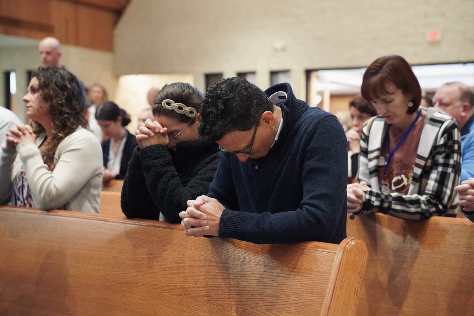 Couples pray during Mass at St. James Parish in Novi during the annual Call to Holiness conference. Approximately 75 couples attended the daylong retreat.