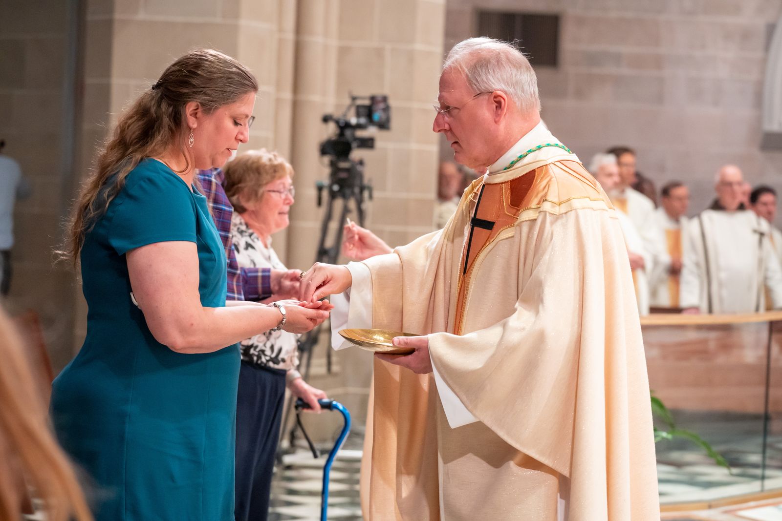 In the first several rows of the church sat numerous people from his hometown of Alpena, a town in Northern Michigan, who made the journey south to support their lifelong friend. Megan Lacross (pictured) from Alpena has known Archbishop Russell since she began dating her husband. Lacross along with her husband and three children presented the gifts during Mass.