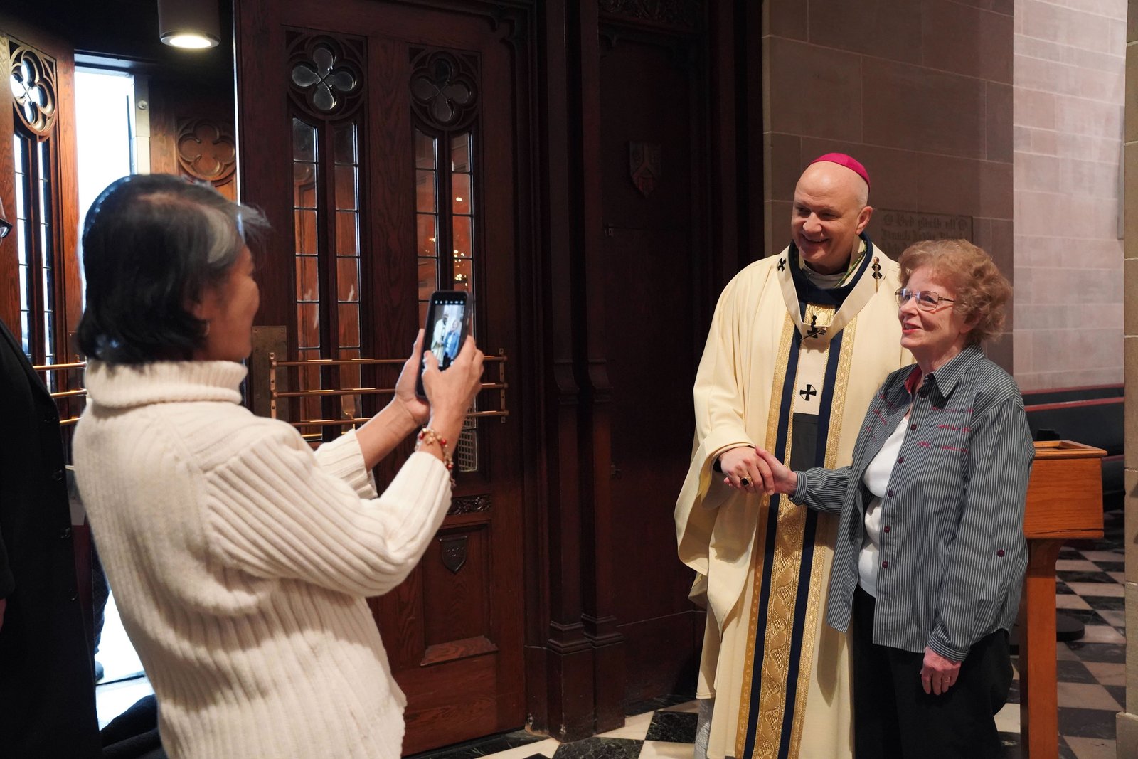 Archbishop Weisenburger greets parishioners and visitors at the Cathedral of the Most Blessed Sacrament after Mass on Dec. 28. Several pilgrims who attended the Mass said they've spent the Jubilee Year of Hope visiting pilgrimage sites throughout the area.
