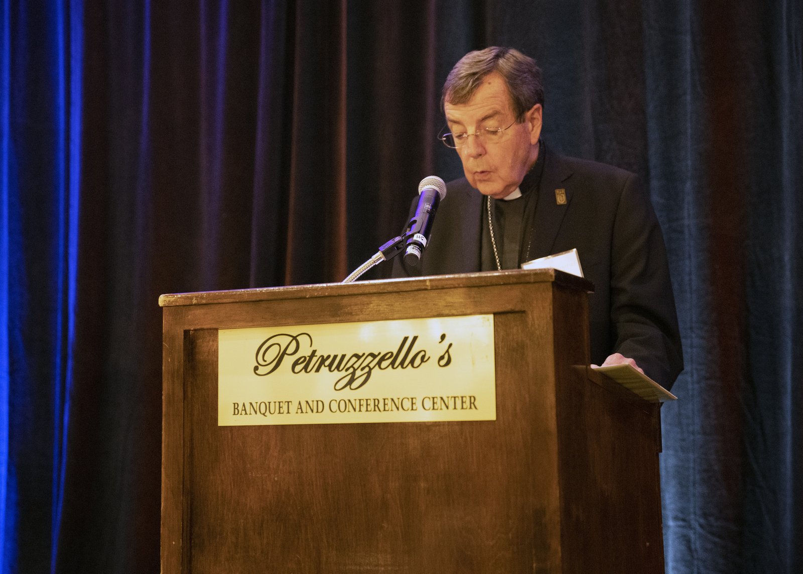 Archbishop Allen H. Vigneron blesses the meal before dinner. The archbishop expressed his gratitude to supporters of Catholic Charities of Southeast Michigan, which is the charitable social service arm of the Archdiocese of Detroit.