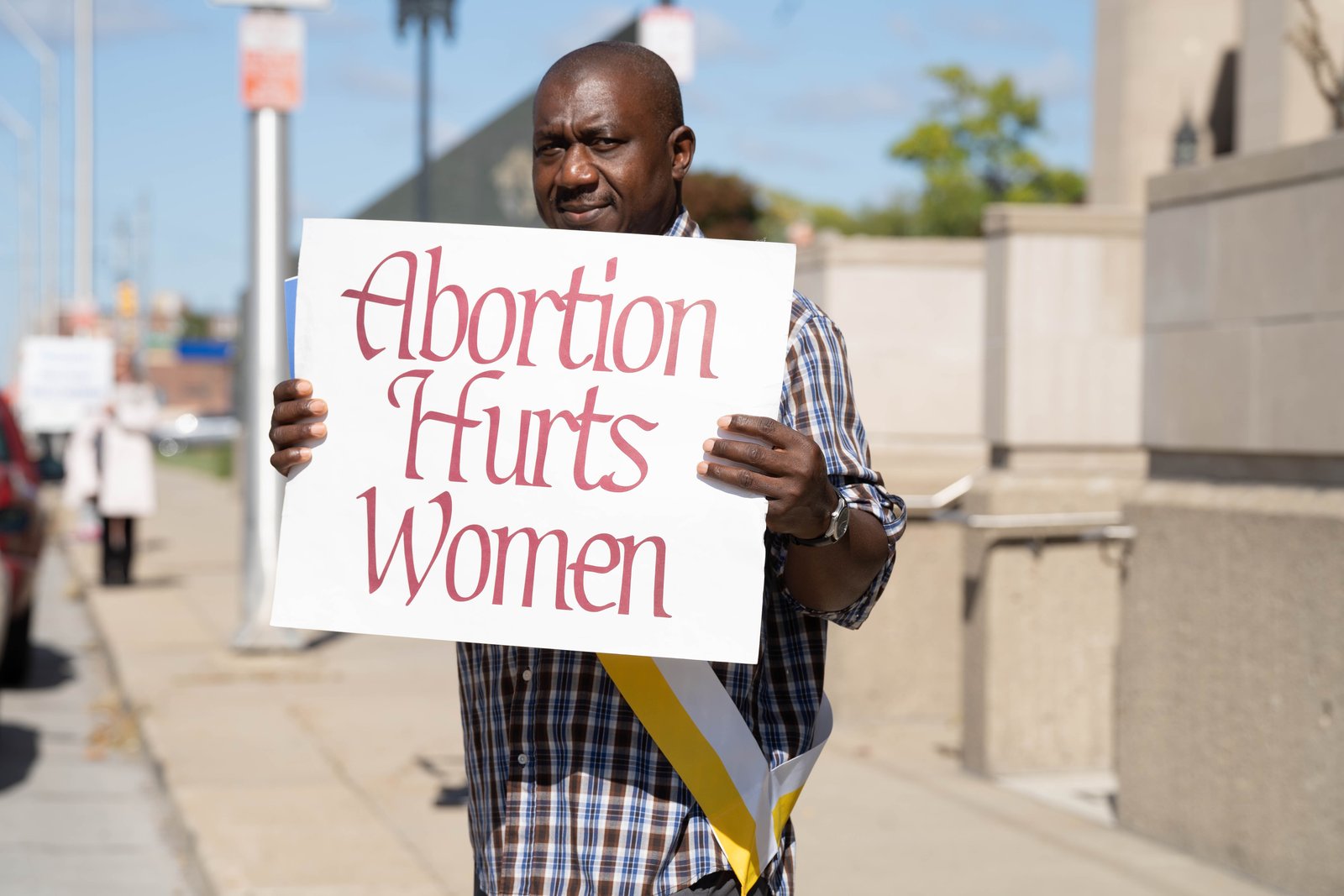 A man holds a sign while participating in a Life Chain outside the Cathedral of the Most Blessed Sacrament on Respect Life Sunday, Oct. 2. The Catholic Church is mobilizing against the "vast and extreme" Proposal 3, which would eliminate virtually all pro-life laws in the state and enshrine abortion as a constitutional right, even for minors without parental consent. (Valaurian Waller | Detroit Catholic)