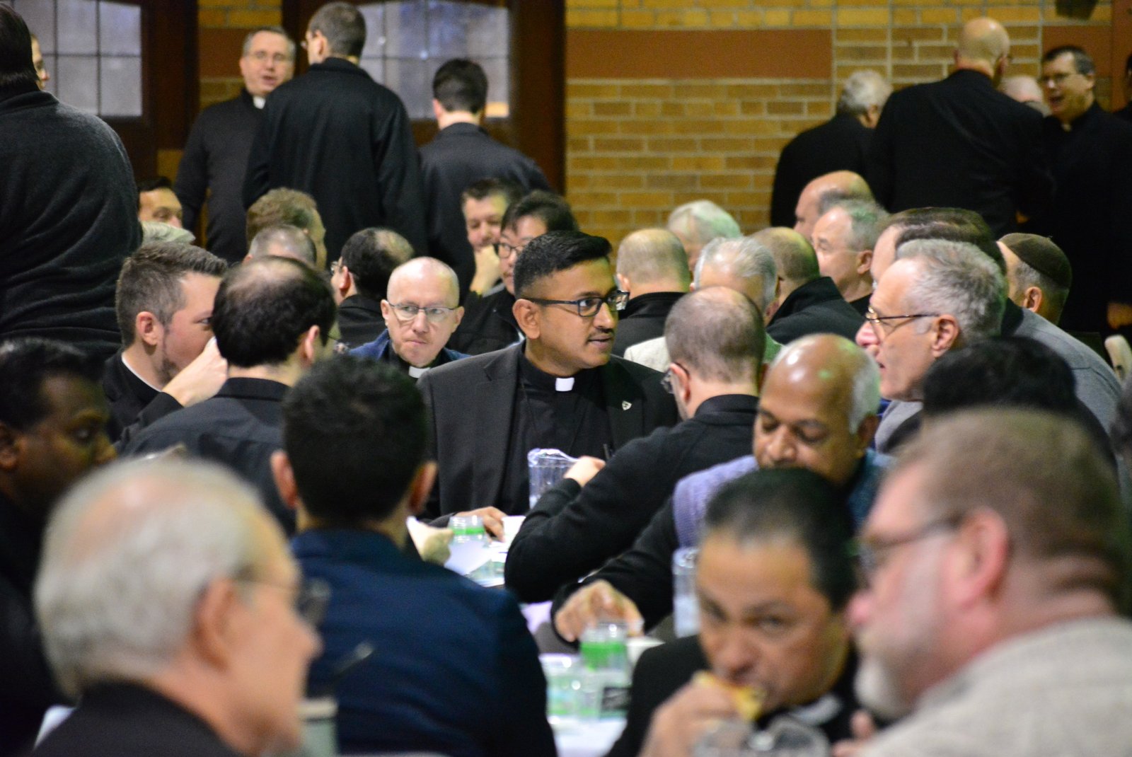 Priests of the Archdiocese of Detroit talk with one another during a pastoral discernment modeling workshop Jan. 14 at Sacred Heart Major Seminary. More than 175 priests gathered to pray, discern and develop pastorate models for the local Church, which then will be refined and presented for parishioner feedback. (Michael Stechschulte | Detroit Catholic)