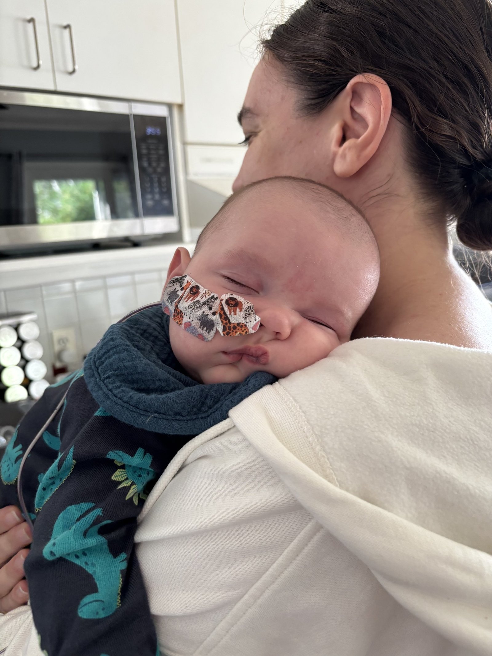 Hannah holds baby David as he naps on her shoulder.
