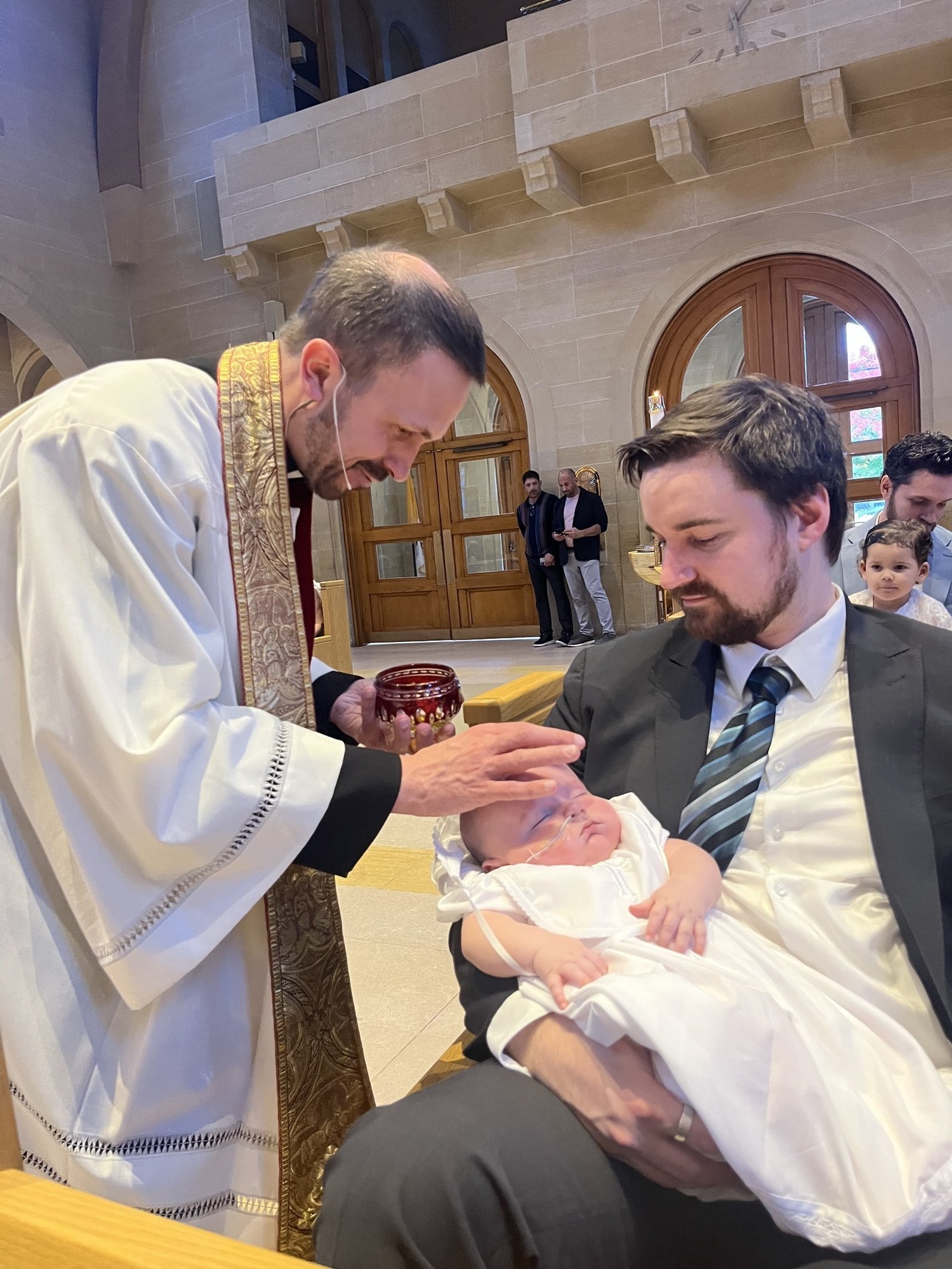 Fr. Paul Snyder of St. Mary Parish in Royal Oak completes the rite of baptism for David in October.