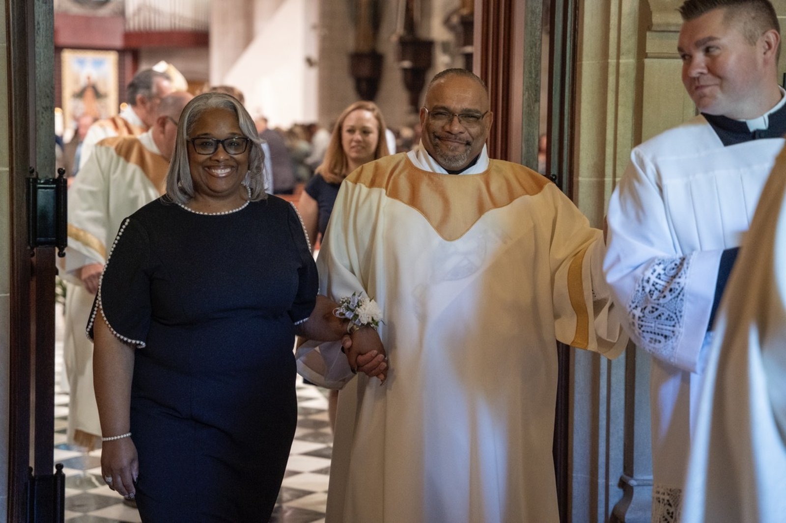 Deacon Joseph Jones and his wife, Bianca, walk out of the Cathedral, hand in hand.