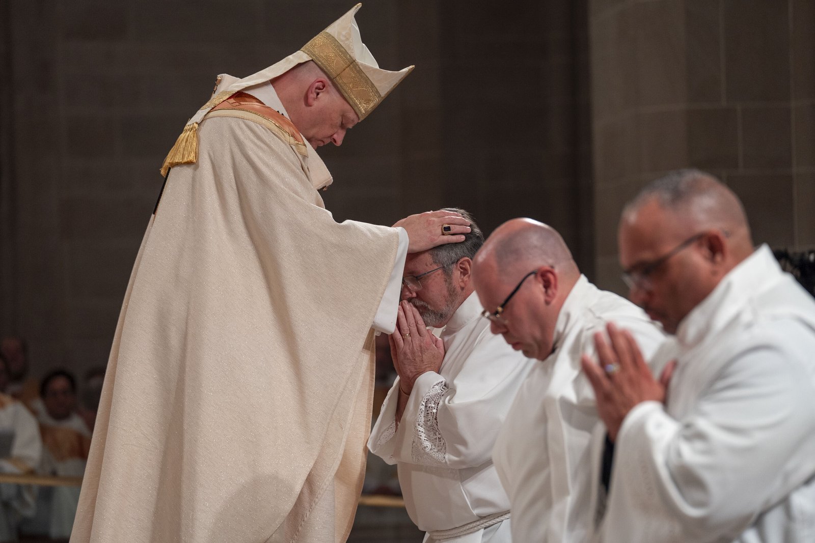 Archbishop Weisenburger lays his hands upon the head of Deacon John Rybski to ordain him to the diaconate Sept. 27 at the Cathedral of the Most Blessed Sacrament, shortly before also ordaining Deacon John Kovacik (center) and Deacon Joseph Jones (right).