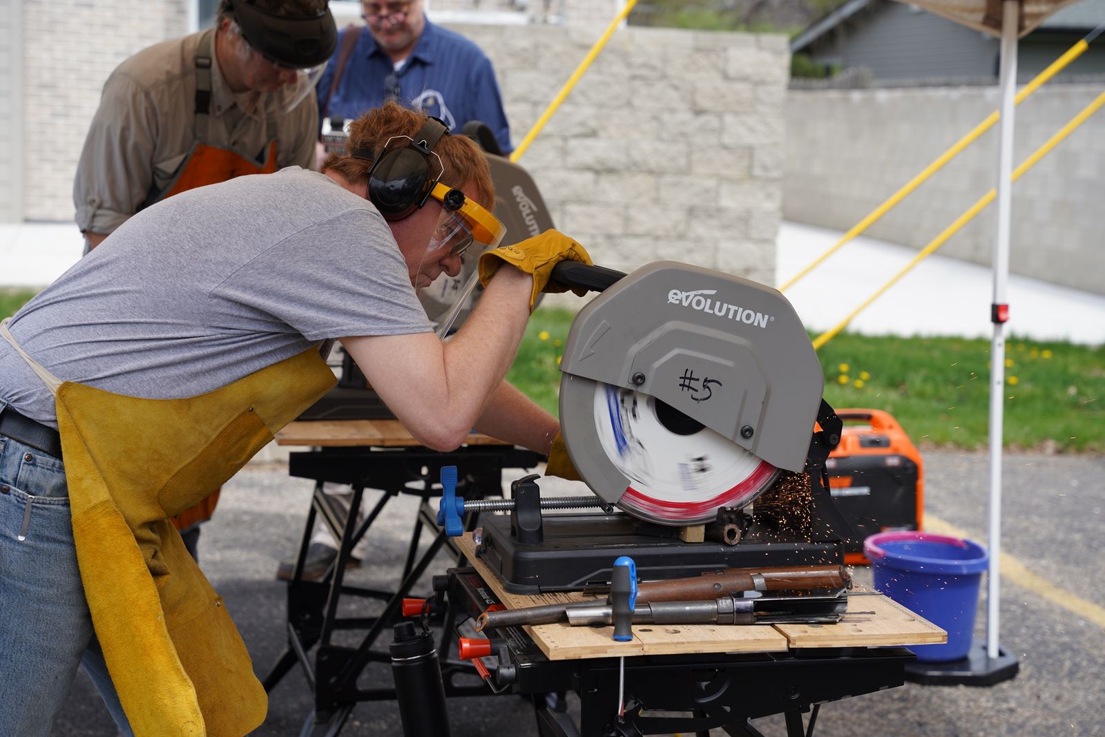 Ken Miller of Disarmory Ministries destroys a firearm with a rotary saw in a Berkley parking lot. Disarmory Ministries accepts unwanted firearms for destruction in exchange for gift cards. The ministry operates Fridays and Saturday, 10 a.m. to 2 p.m. at 2312 Greenfield Road, Berkley. (Daniel Meloy | Detroit Catholic)