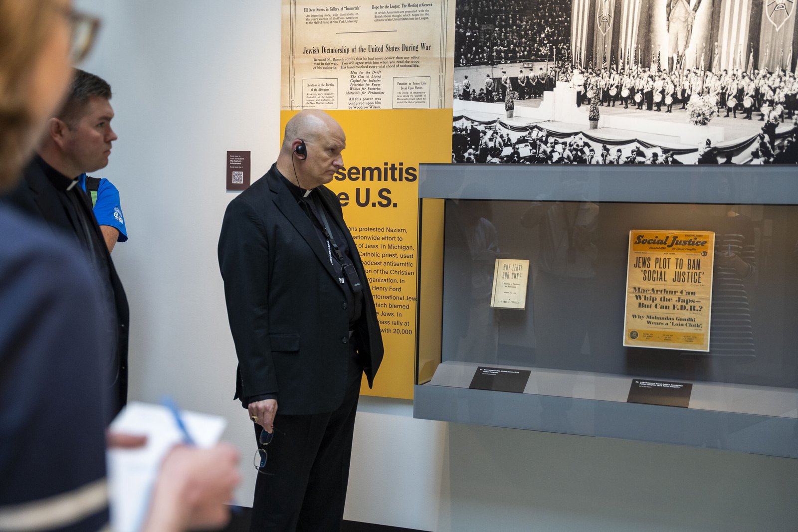 Archbishop Weisenburger listens to the history of antisemitism in Metro Detroit, including Fr. Charles Coughlin, the founding pastor of the National Shrine of the Little Flower Basilica in Royal Oak, who through his radio program and newspaper "Social Justice" published conspiracies about Jews. The newspaper and radio program were shut down in 1942, by order of then-Detroit Archbishop Edward A. Mooney.