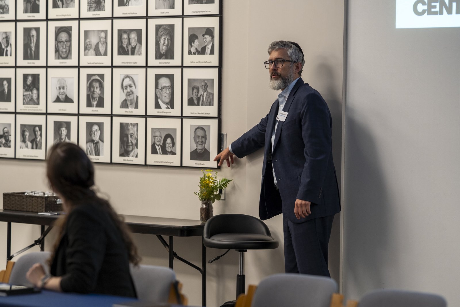 Rabbi Eli Mayerfeld, CEO of The Zekelman Holocaust Center, points to the portraits of Holocaust survivors who moved to Michigan after World War II and worked to build and promote The Zekelman Holocaust Center as a place to educate the public about the horrors of the Holocaust and the lives of more than 8 million people who were killed.