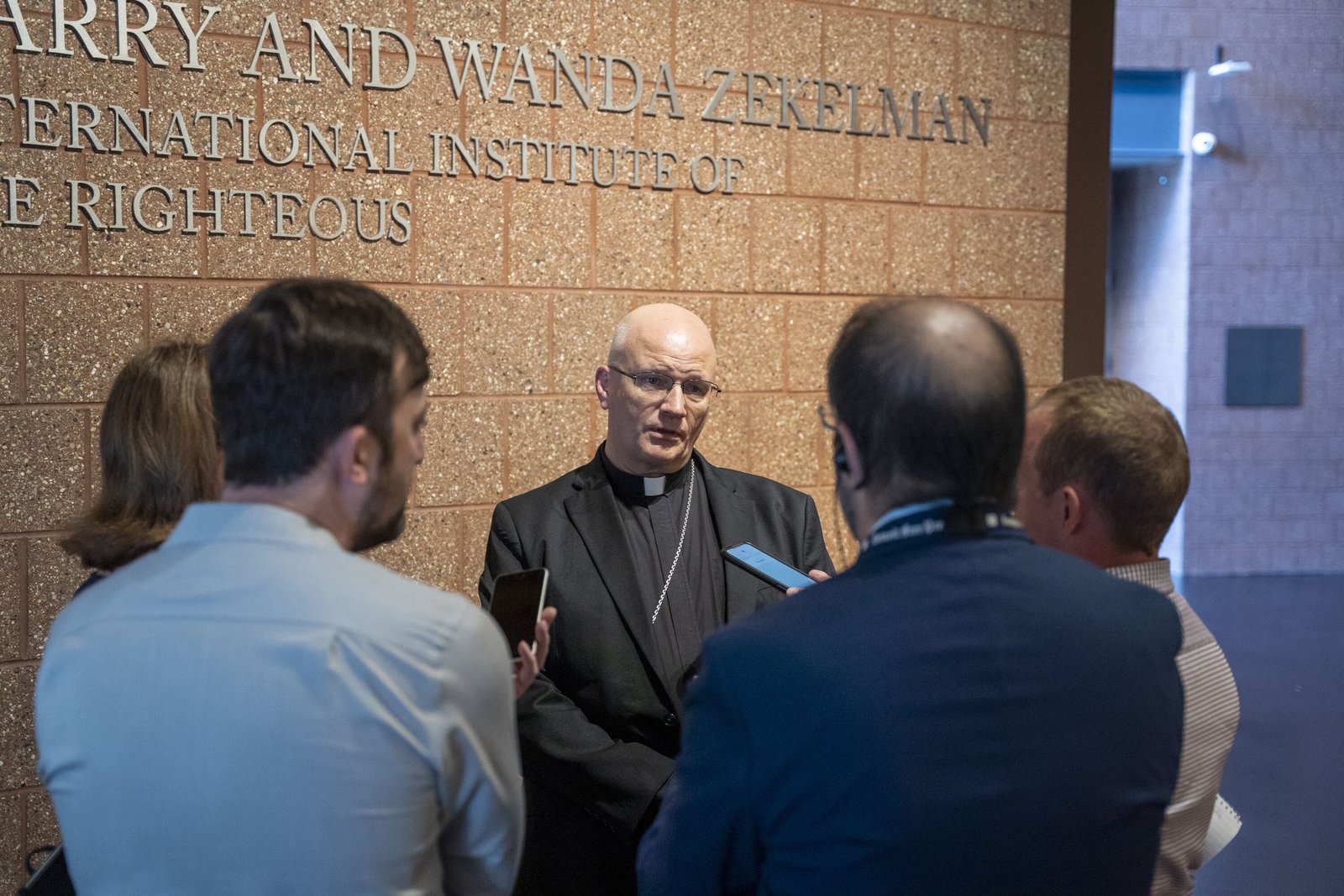 Archbishop Weisenburger speaks with a pool of reporters about his visit to The Zekelman Holocaust Center. The archbishop has visited Holocaust museums in Washington, D.C., and in Israel, as well as Anne Frank's House in Amsterdam. The archbishop spoke about ongoing suffering happening today, including the war in Gaza.
