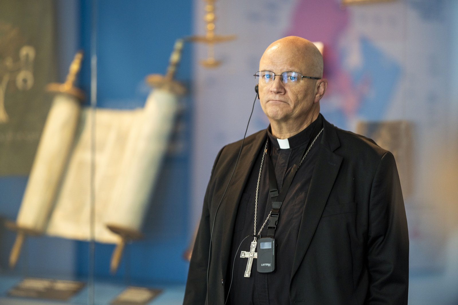 Archbishop Weisenburger views a Torah scroll from among the many artifacts and testimonials preserved from Holocaust survivors and victims at the Farmington Hills memorial center.