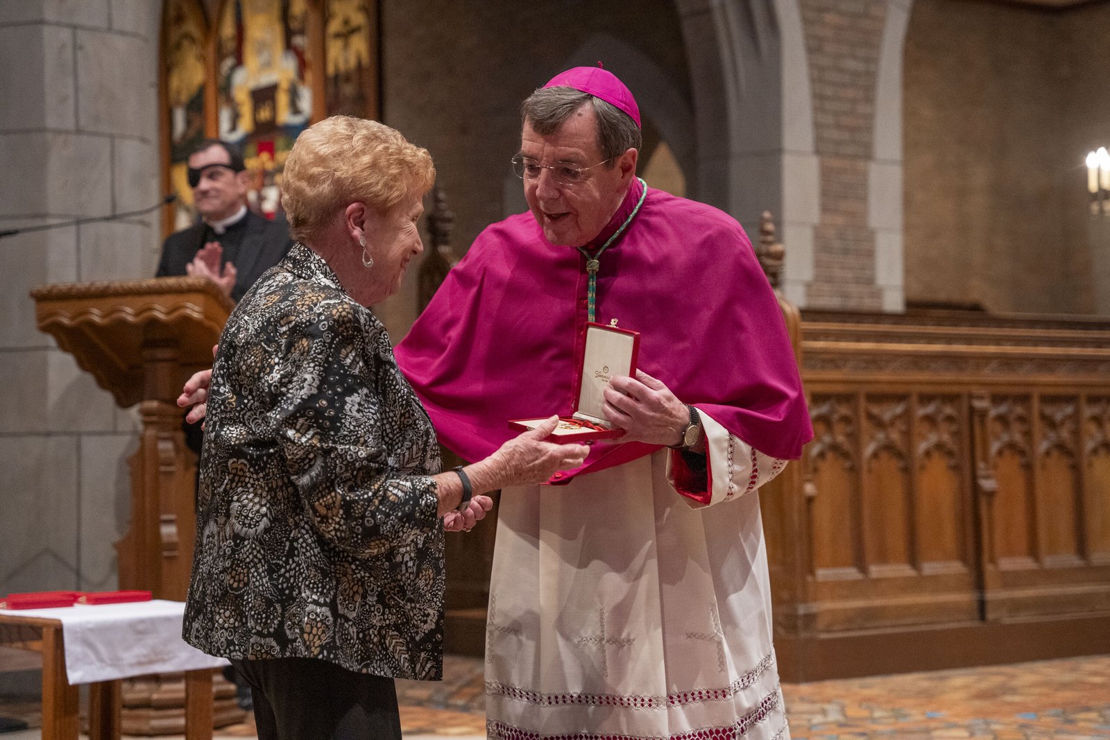 Mary Erdman receives the Order of St. Sylvester from Archbishop Vigneron for her years of service to the Church, including as the longtime secretary to retired Detroit Cardinal Adam J. Maida.