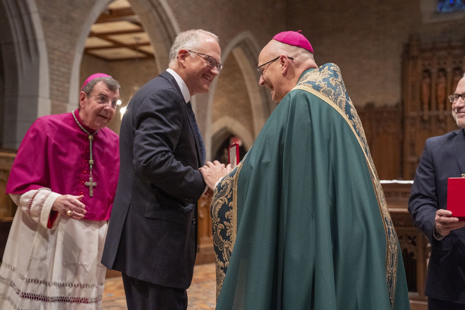 Michael Vlasic, who chaired the Archdiocese of Detroit's "Changing Lives Together" campaign, and currently serves on the boards of Catholic Funeral and Cemetery Services and the Catholic Foundation of Michigan, receives words of congratulations from Archbishop Weisenburger.