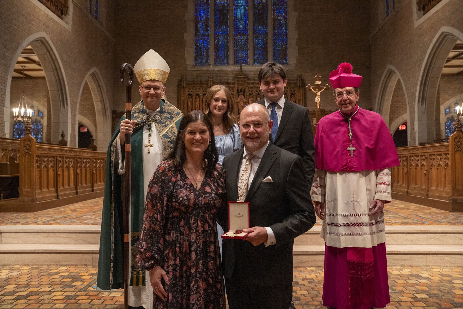 Michael Trueman, chancellor of the Archdiocese of Detroit, was bestowed a Knight of the Order of St. Sylvester. He is pictured with members of his family.