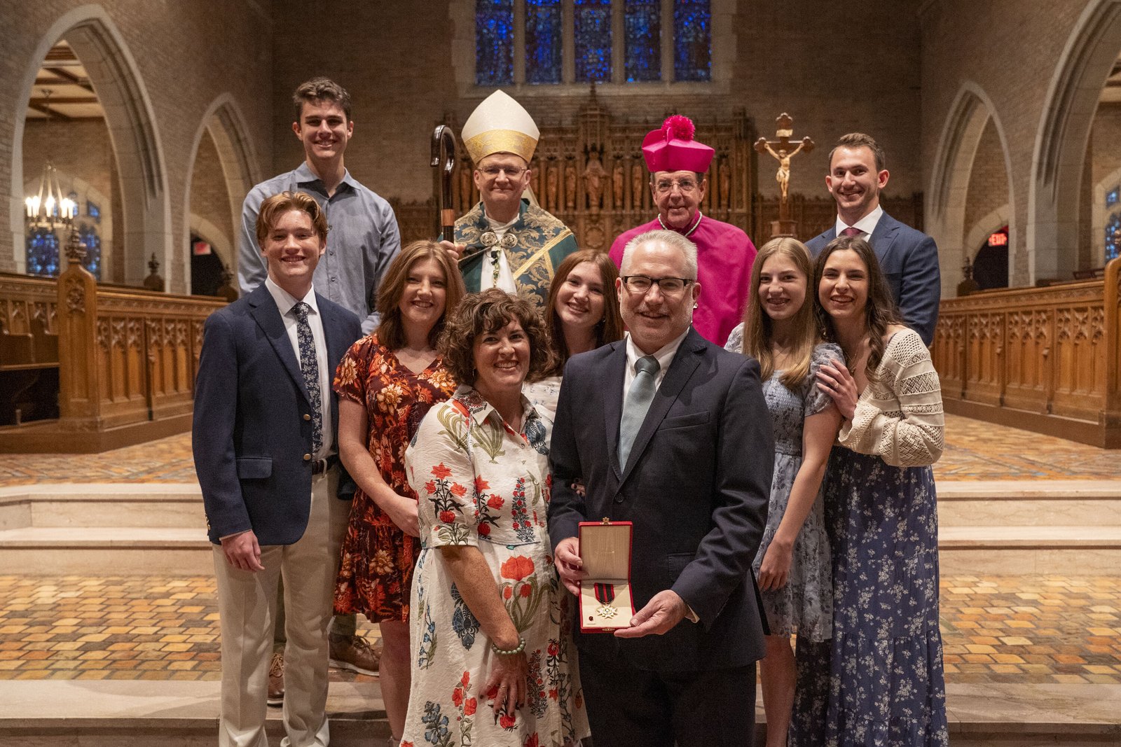 Paul Propson, CEO of Catholic Charities of Southeast Michigan, with his family and Archbishops Weisenburger and Vigneron. Propson has led Catholic Charities of Southeast Michigan since 2019.