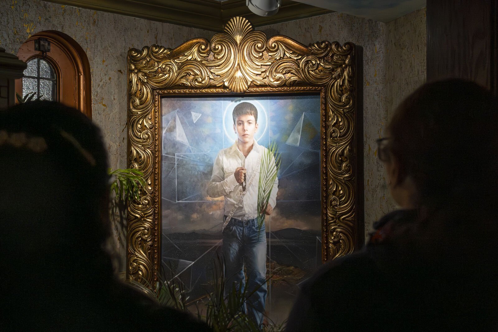 Parishioners look upon a portrait of St. José Sánchez del Río at Most Holy Redeemer Church on his feast day, Feb. 10. St. José Sánchez del Río was martyred at age 14 by government forces who asked him to renounce his faith. He refused, proclaiming "Viva, Cristo Rey" before his execution.