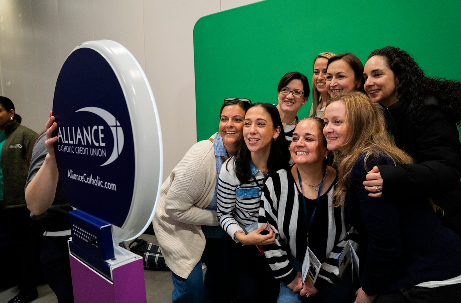 Educators smile for a group picture during a break in between sessions during the F.I.R.E. conference April 4 at the Suburban Collection Showplace in Novi.