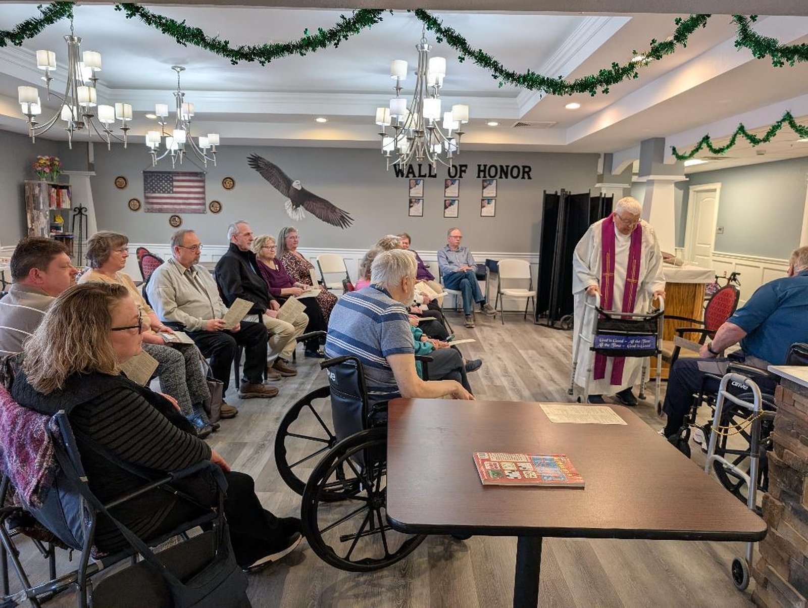 Fr. Rich Treml celebrates Mass with 17 people — including fellow residents and former parishioners — in the activity room at Charter Senior Living in Davison, where he now lives. The priest's weekly Masses have become a hit at his new residence.