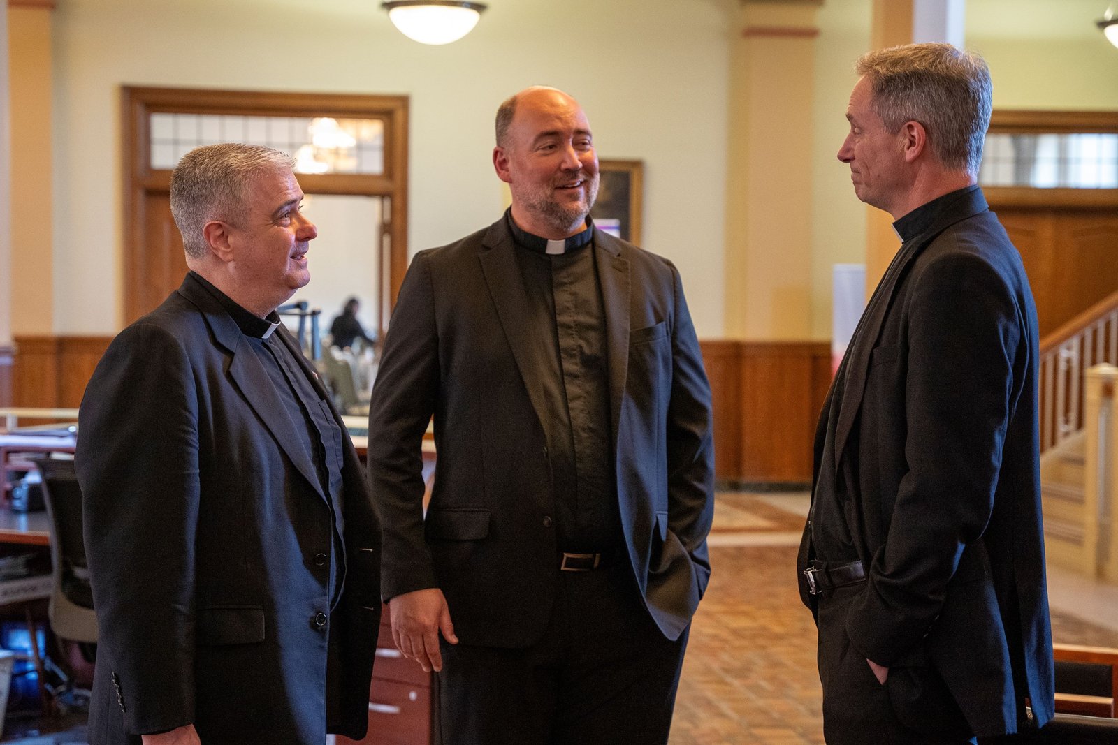 Fr. Creagh, left, speaks with his two predecessors, former Sacred Heart rectors Fr. Stephen Burr, center, and Msgr. Todd Lajiness, during a meet-and-greet at the seminary in April. (Valaurian Waller | Detroit Catholic)
