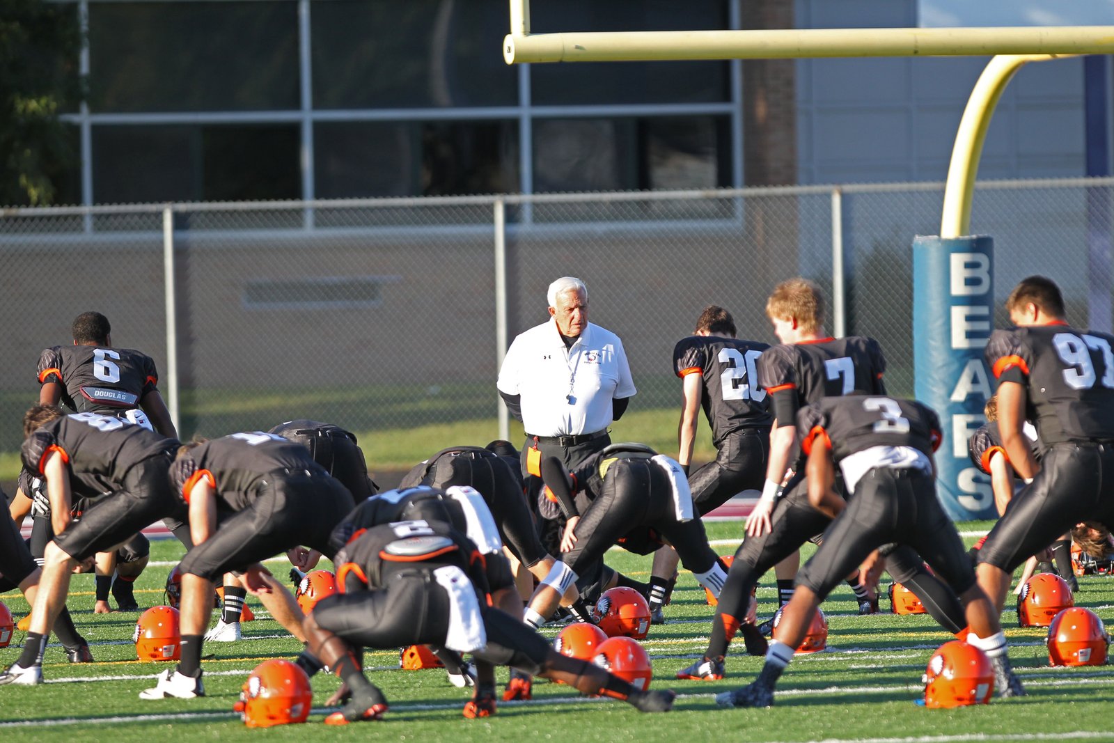 Legendary Al Fracassa, pictured leading his team during warmups in 2013, enjoyed a 53-year coaching career: at Royal Oak Shrine (1960-1966: 44-19-5) and then at Brother Rice (1968-2013: 386-98-2). His overall record of 430 wins is second best in state football prep annals. (Detroit Catholic file photo)