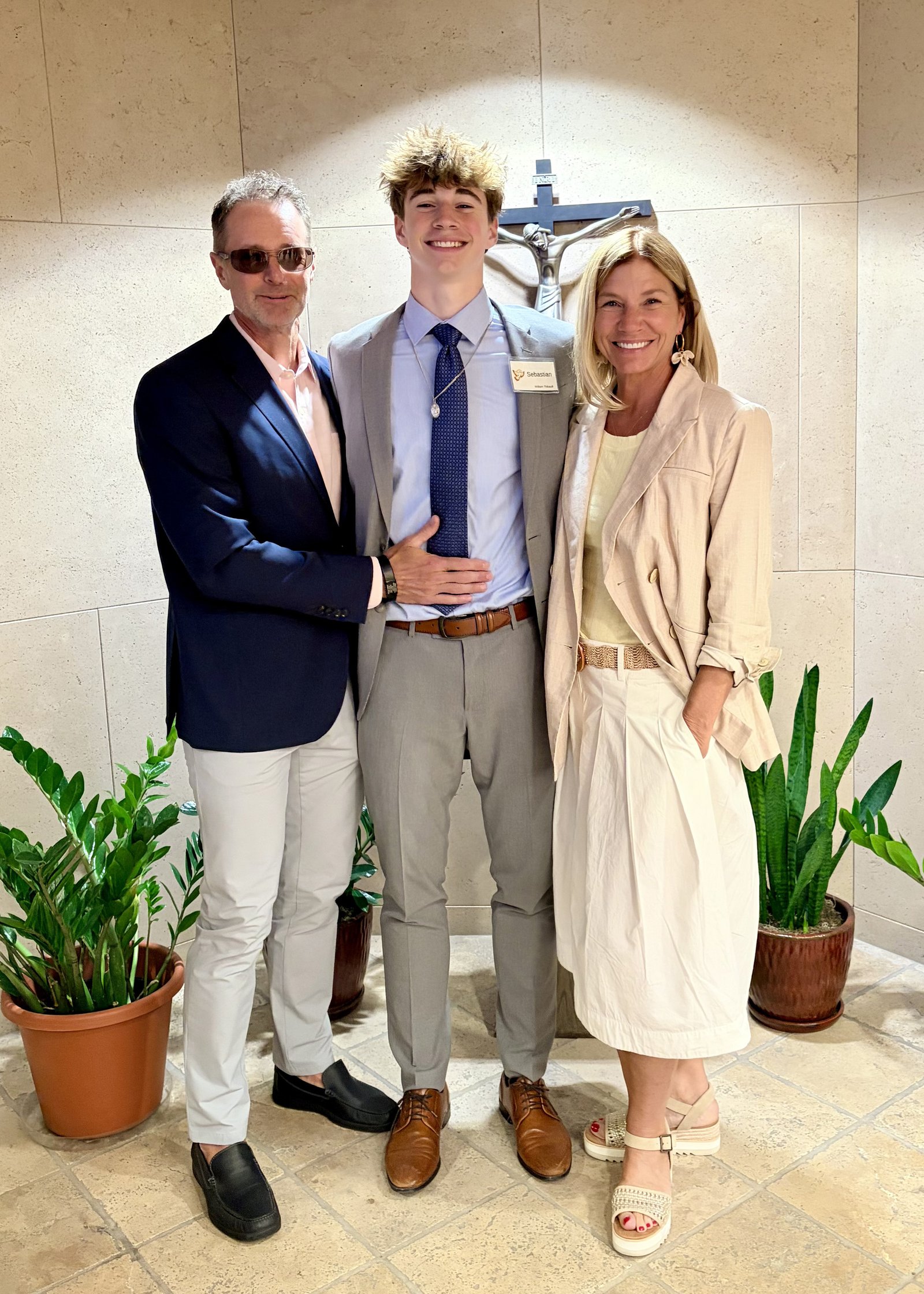 Tony and Marcy Thibault stand with their son, William, after he received the sacraments of initiation in April. Tony and Marcy were inspired by their son’s faith and will begin OCIA this fall.