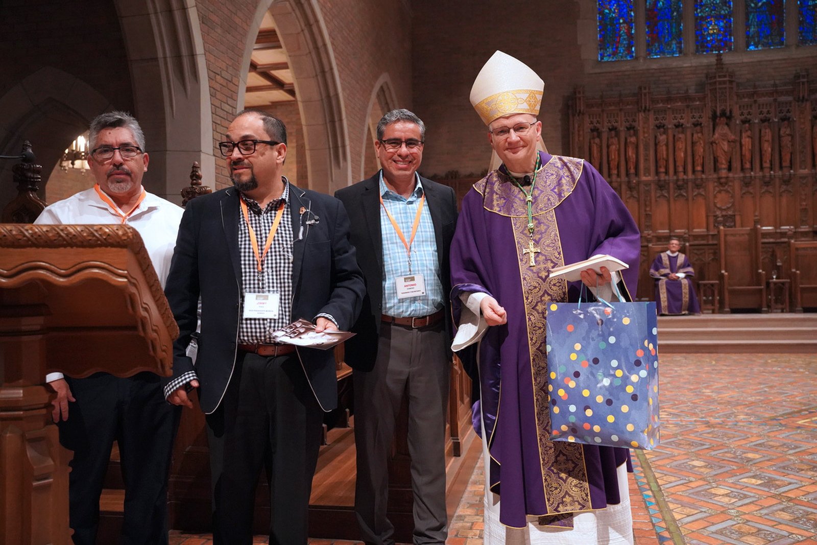 Hispanic ministry representatives greet Archbishop Edward J. Weisenburger after Mass at Sacred Heart Major Seminary on March 30, where the archbishop celebrated the opening liturgy for the 16th Hispanic Men's Conference.
