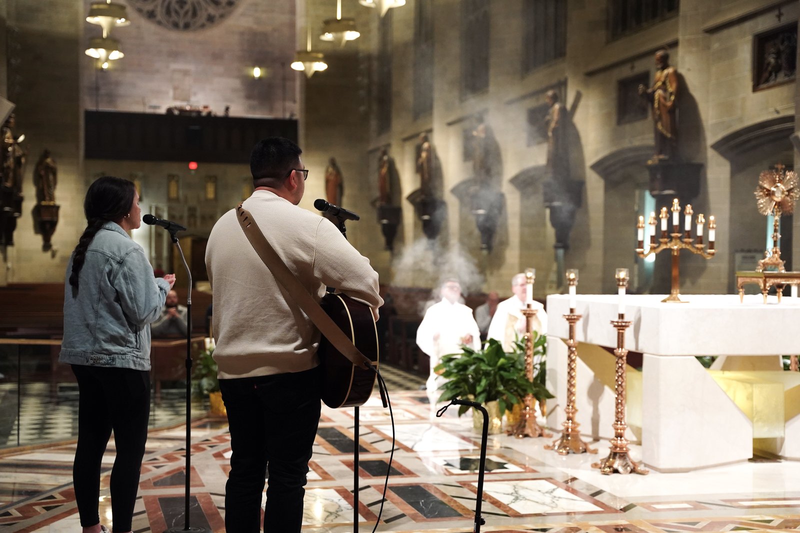 Isabella Ponce and Gerardo Butalid perform during Eucharistic adoration during a holy hour for the archdiocesan restructuring process at the Cathedral of the Most Blessed Sacrament on Jan. 14.