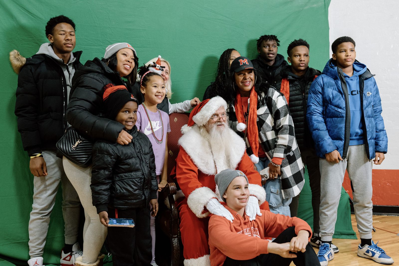 Families pose for photos with Santa Claus during the Orchard Lake Schools' annual "Mingle All the Way" celebration Nov. 19. (Alissa Tuttle | Special to Detroit Catholic)
