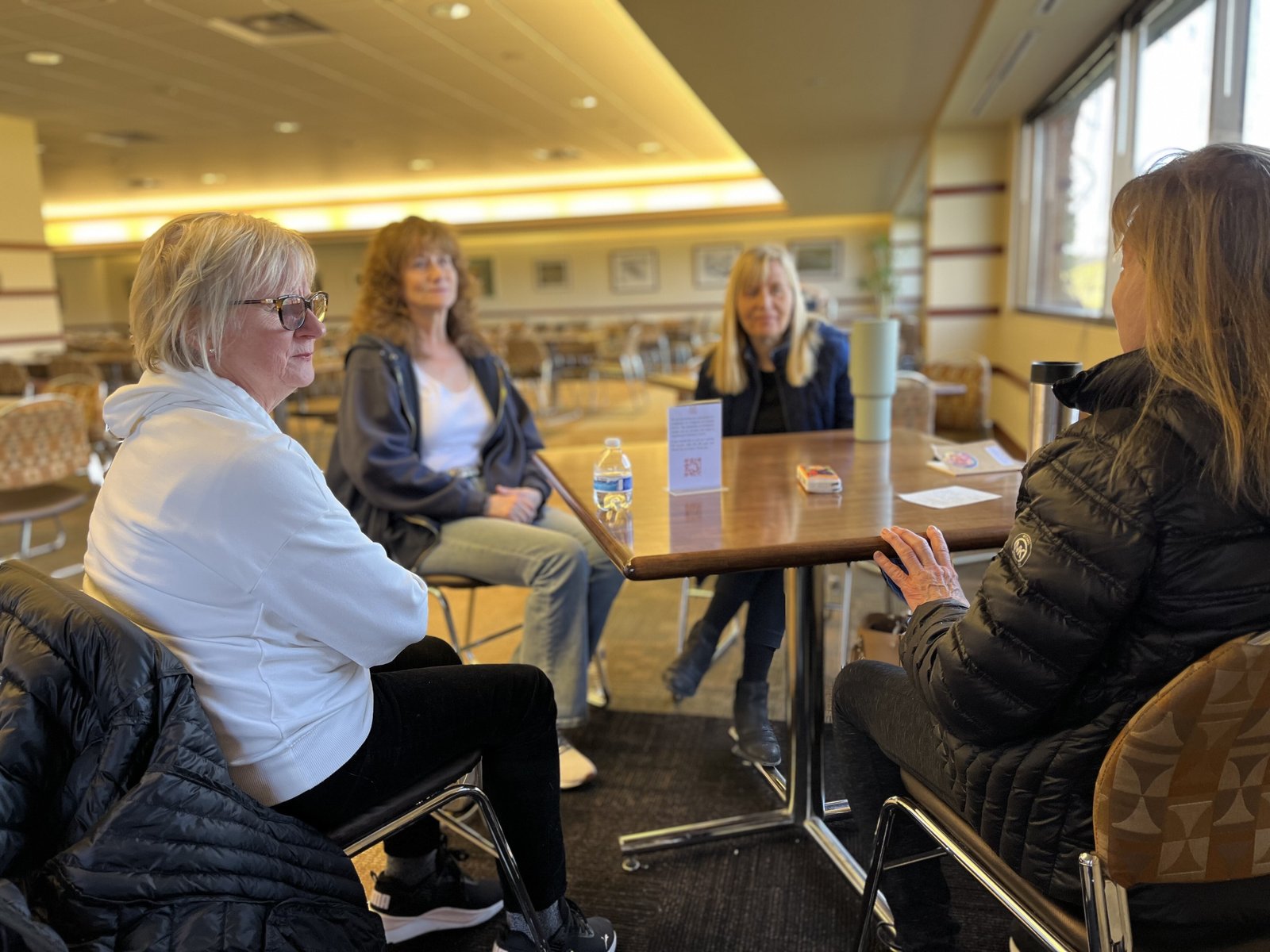 Members of the Widows Might ministry accompany one another on March 21 over a coffee get-together — they call it “Widows Might Brew” — which meets once a month on Friday mornings.