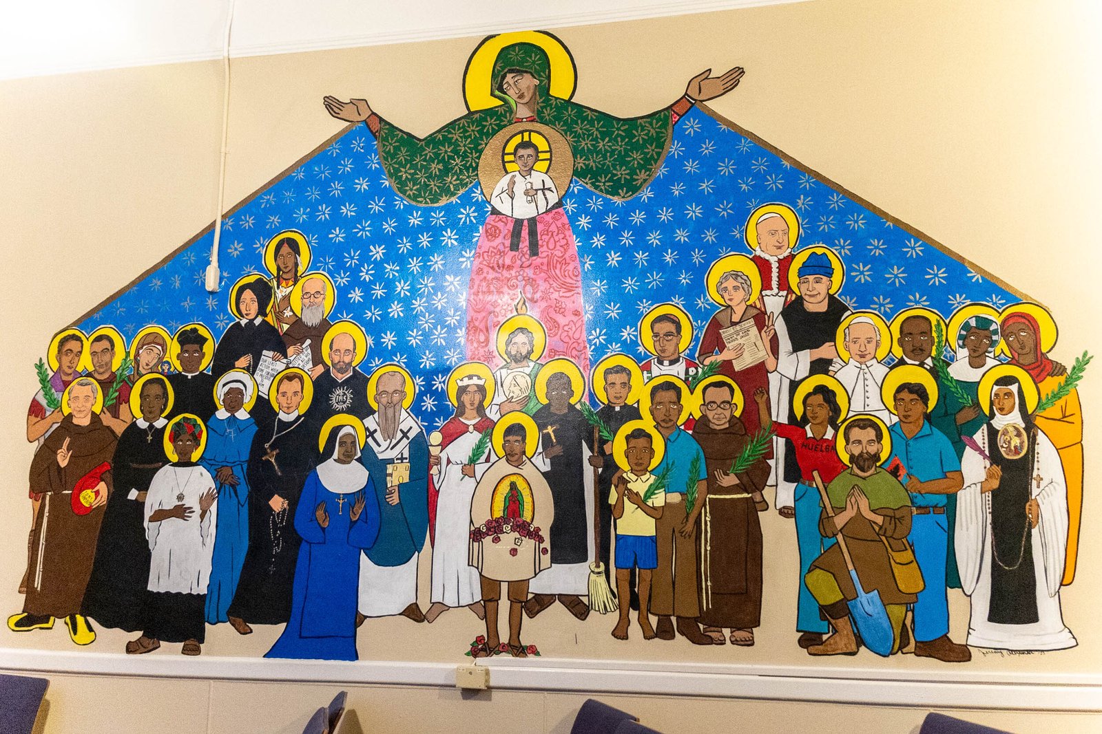 The mural, completed in a traditional Byzantine iconographical style, features 37 saints, artists, poets and civil rights leaders, topped by the Blessed Virgin Mary and the Christ Child.