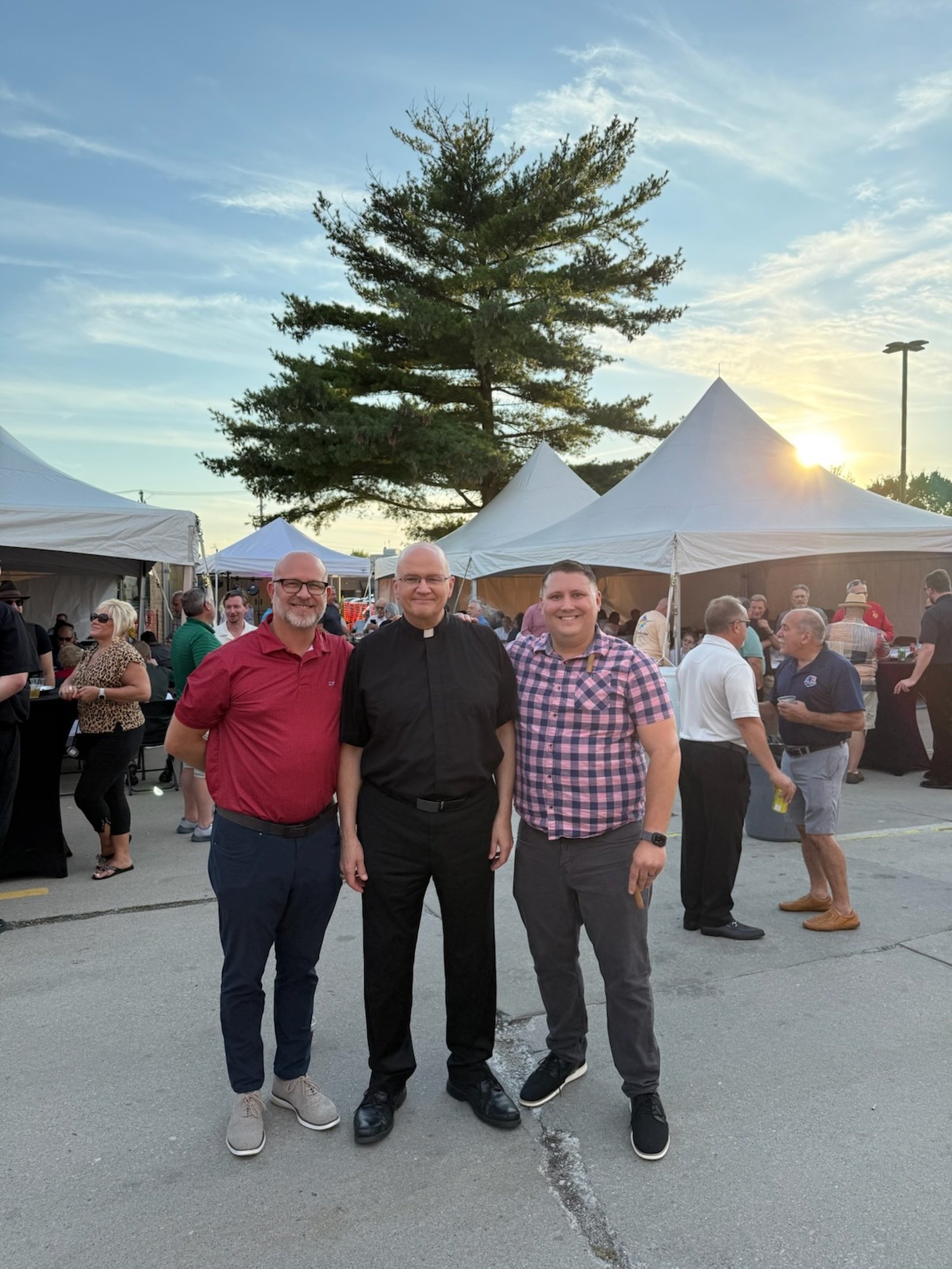 Joining the archbishop are Michael Smiatacz, left, and Chris Rettich, who both work in the Archdiocese of Detroit's Department of Mission Advancement.