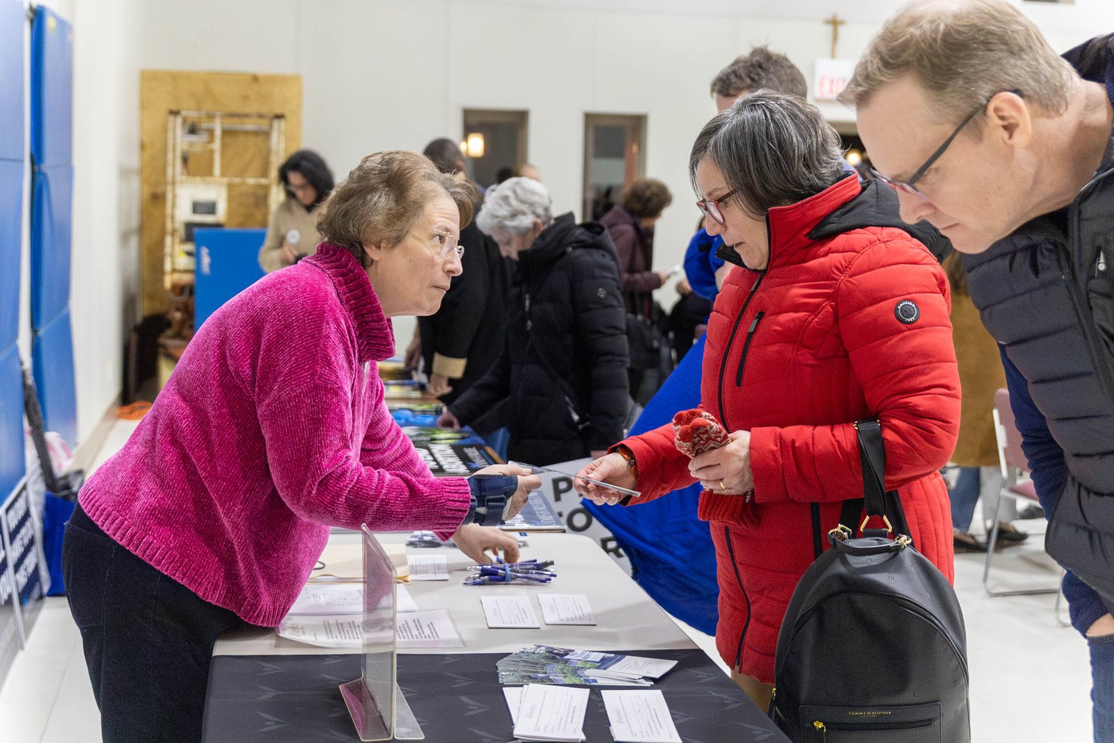 A 40 Days for Life Ferndale vigil representative hands out signs and literature to volunteers during the kickoff event for 40 Days for Life on Feb. 13 at St. Mary Parish in Royal Oak.