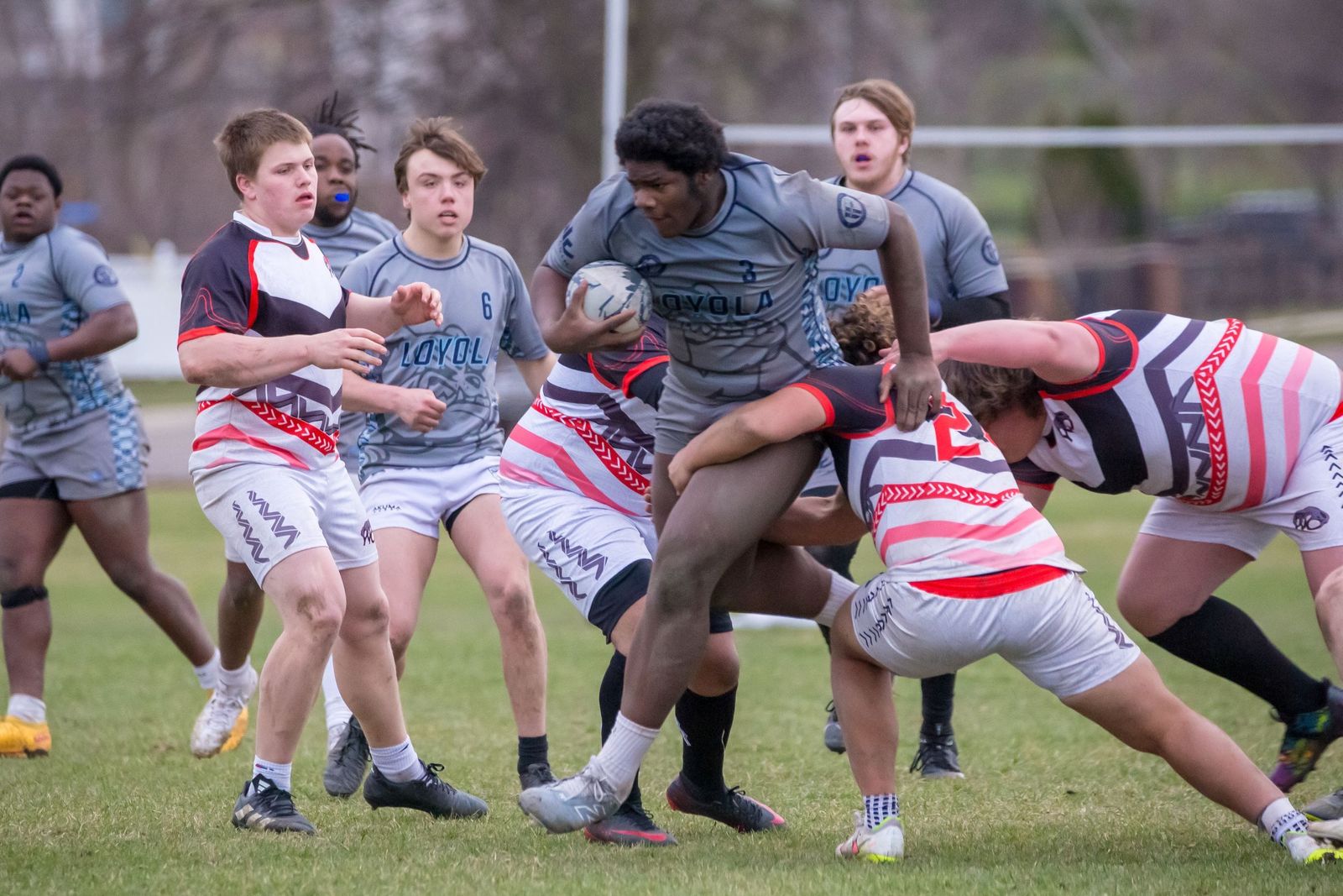 Romell Murry breaks away from Holland West Ottawa would-be tacklers and advances the ball. Loyola fell to West Ottawa, 29-26, on the last play of the match. (Photo by Kevin Roberts | Special to Detroit Catholic)
