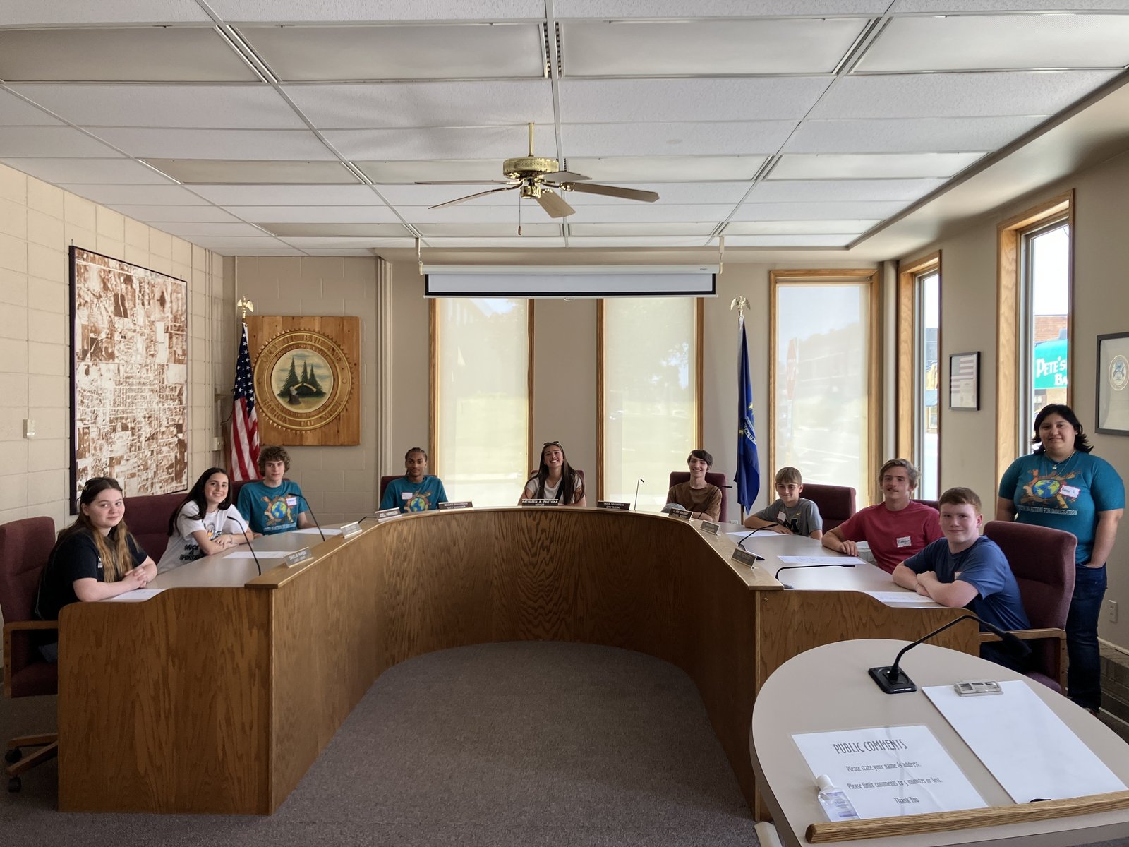 Teens part of the Strangers No Longer immigration immersion trip meet at the Huron County Building in Bad Axe to discuss with local officials the living conditions of migrant workers.
