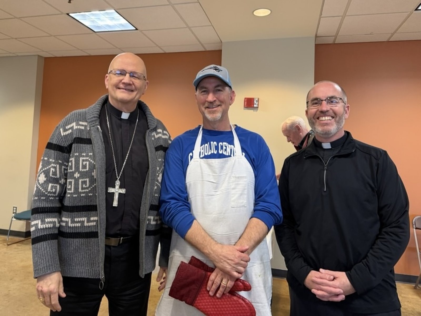 Archbishop Edward J. Weisenburger, left, is pictured with Fr. Timothy Birney, right, vicar general and moderator of the curia for the Archdiocese of Detroit, along with Fr. Birney's brother, Mike Birney, who led Our Lady of Good Counsel's fish fry.