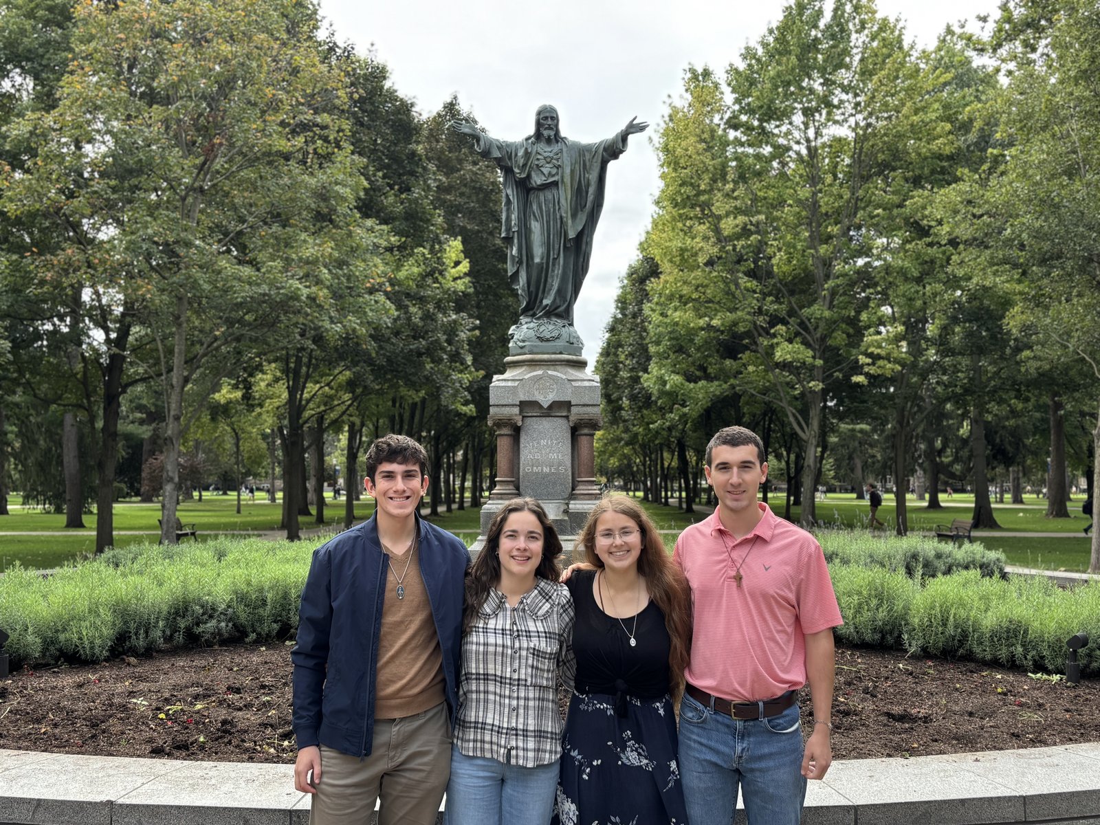Members of the Consecration 2026 Committee, all sophomores, pose for a photo in front of the Sacred Heart of Jesus statue on the University of Notre Dame campus. From left to right: Luke Fisher, Clare Hettich, Sabrina Richter and Gabriel Wollak. (Courtesy of Luke Fisher)