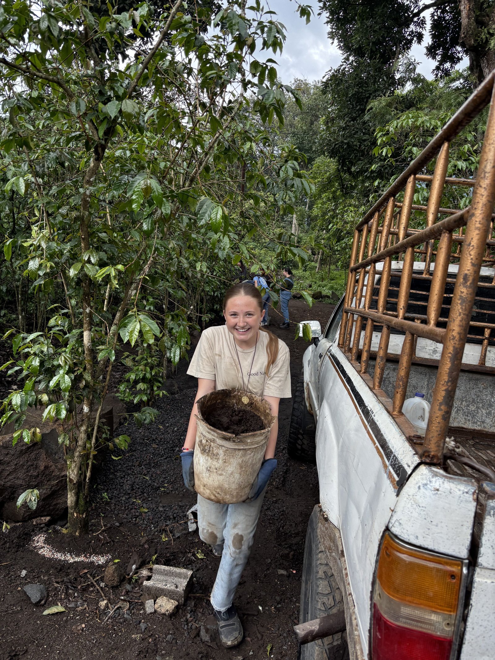 Leona Knudsen, SMCC senior, carries dirt to help level a floor before concrete can be poured in a new house in San Lucas Tolimán, Guatemala.