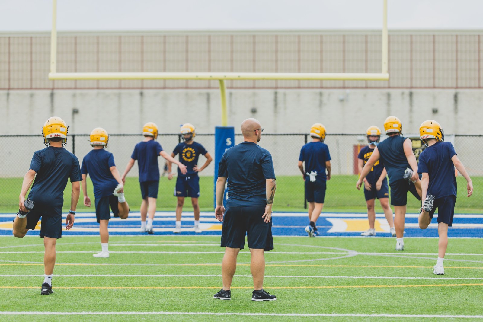 Under the watchful eye of new coach Chris Kelly, Royal Oak Shrine football players complete line drills on a hot afternoon. (Photo by Katrina Shammami | Special to Detroit Catholic)