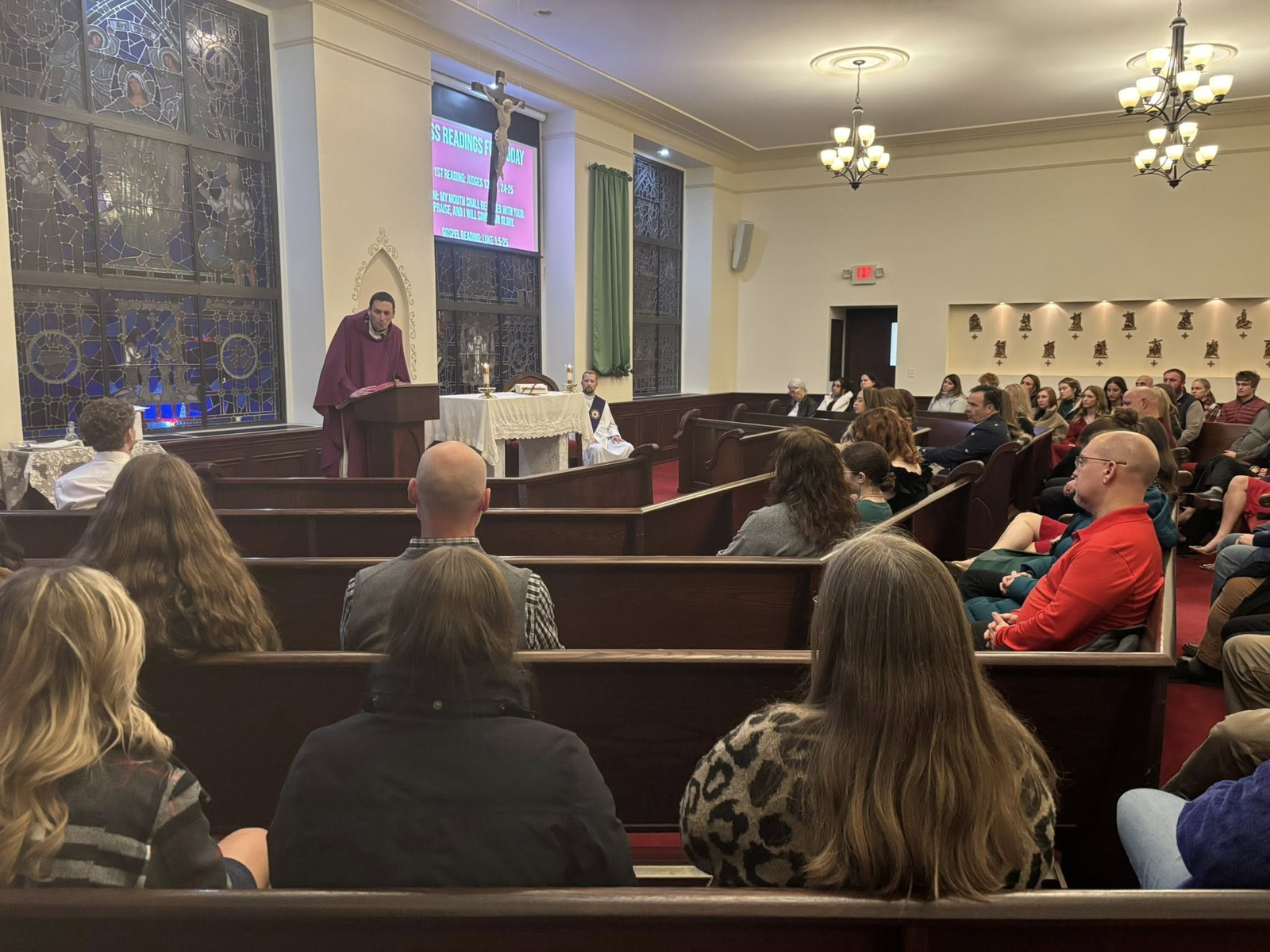 Fr. Kevin Roelant, assisted by Deacon Nathan Krawetzke, celebrates Mass at SMCC in December 2025 before the annual Christmas Ball for the senior class. (Photo courtesy of St. Mary Catholic Central)