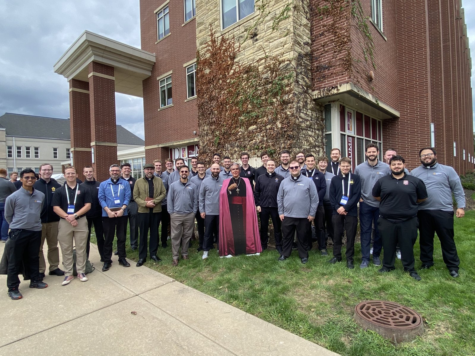 A group photo with a life-sized cutout of Archbishop Sheen in Peoria, Ill., before heading off to St. Louis for Thursday's beatification Mass.