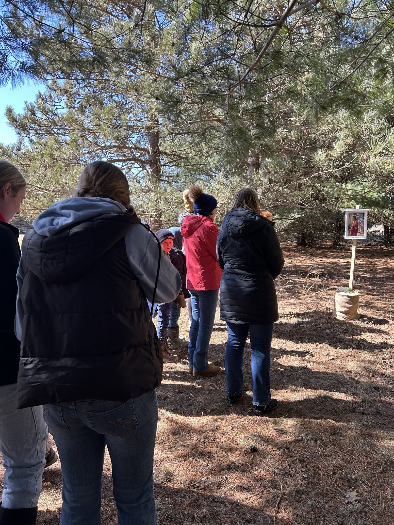 Members of the parish stop to pray at various Stations of the Cross along a path through the woods near the North Branch parish on the first Sunday of Lent.
