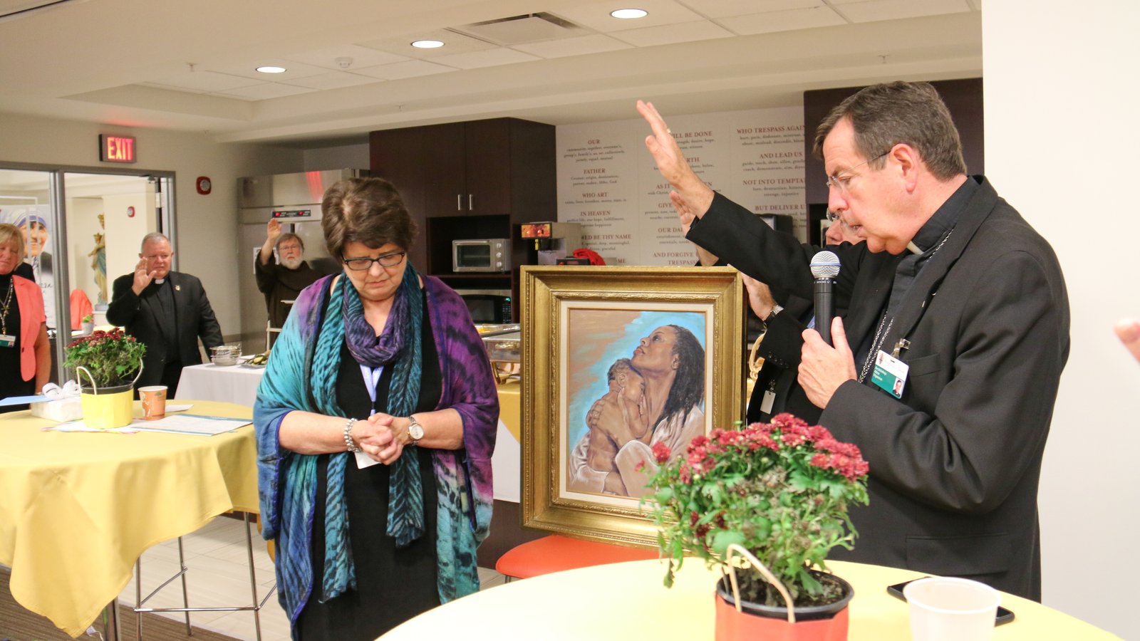 Archbishop Vigneron prays over Pam Beech, human resources director for the Archdiocese of Detroit, during Beech's retirement celebration on Sept. 15, 2016. (Jonathan Francis | Detroit Catholic file photo)