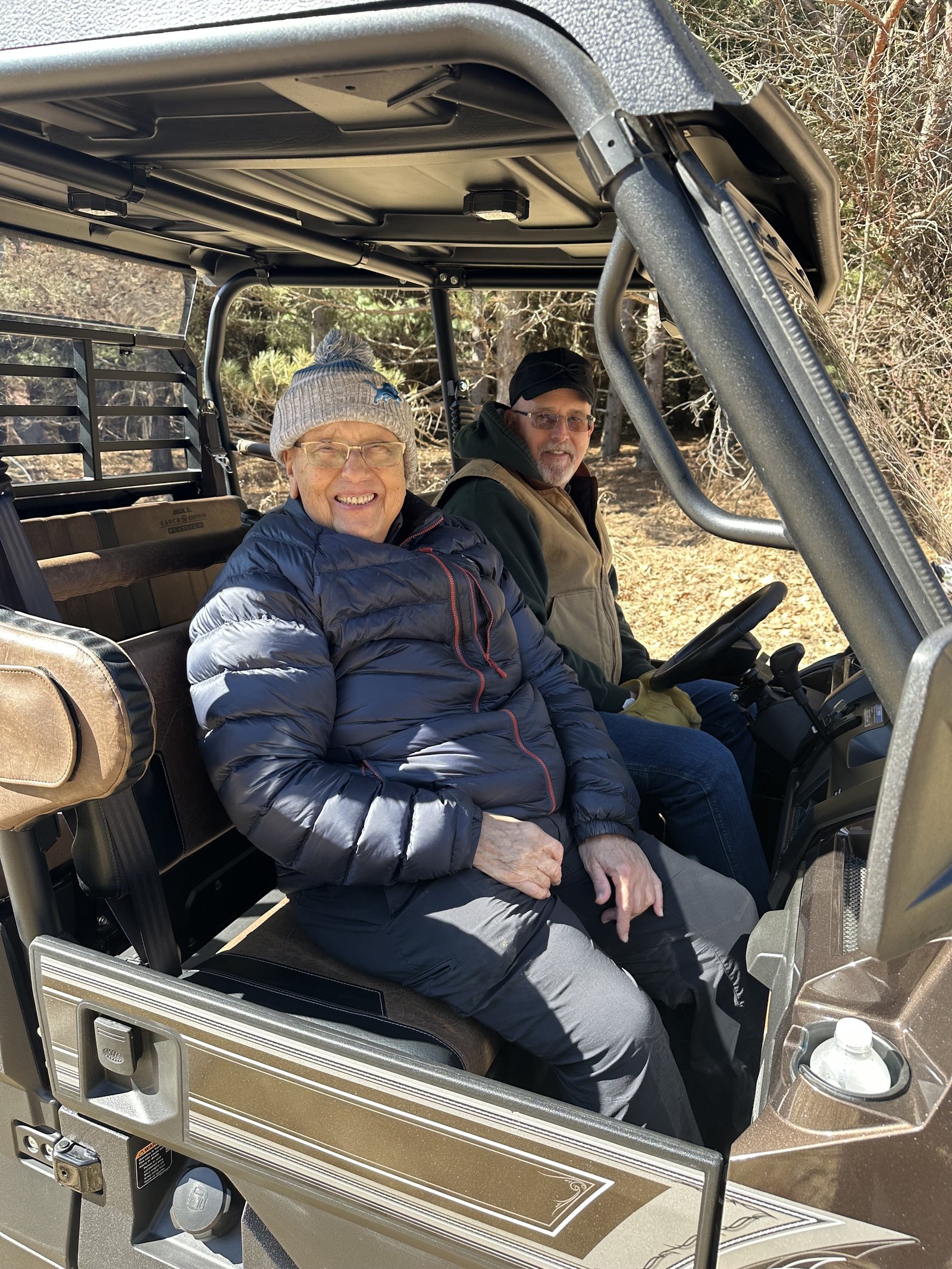 SS. Peter and Paul's pastor, Fr. Richard Treml, gets a ride from a parishioner on a side-by-side vehicle to each Station of the Cross in a wooded setting as part of a special Lenten meditation put on by parish youth.