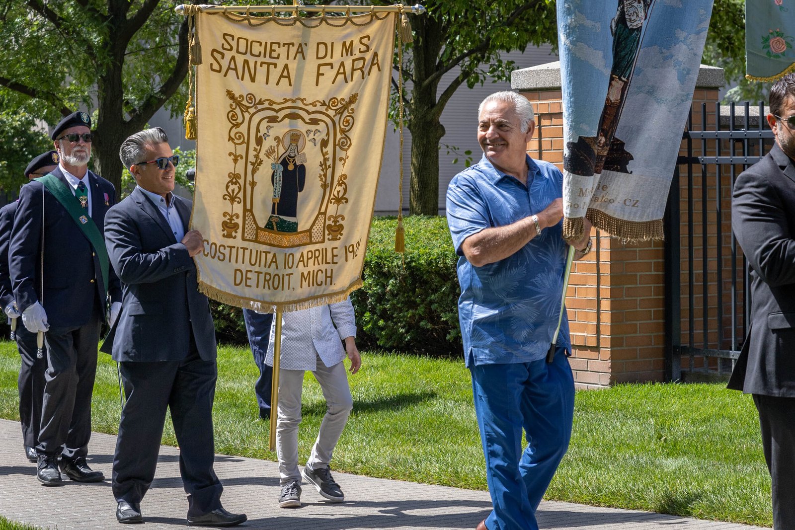 The procession included members of various local clubs, who carried representative banners and flags.