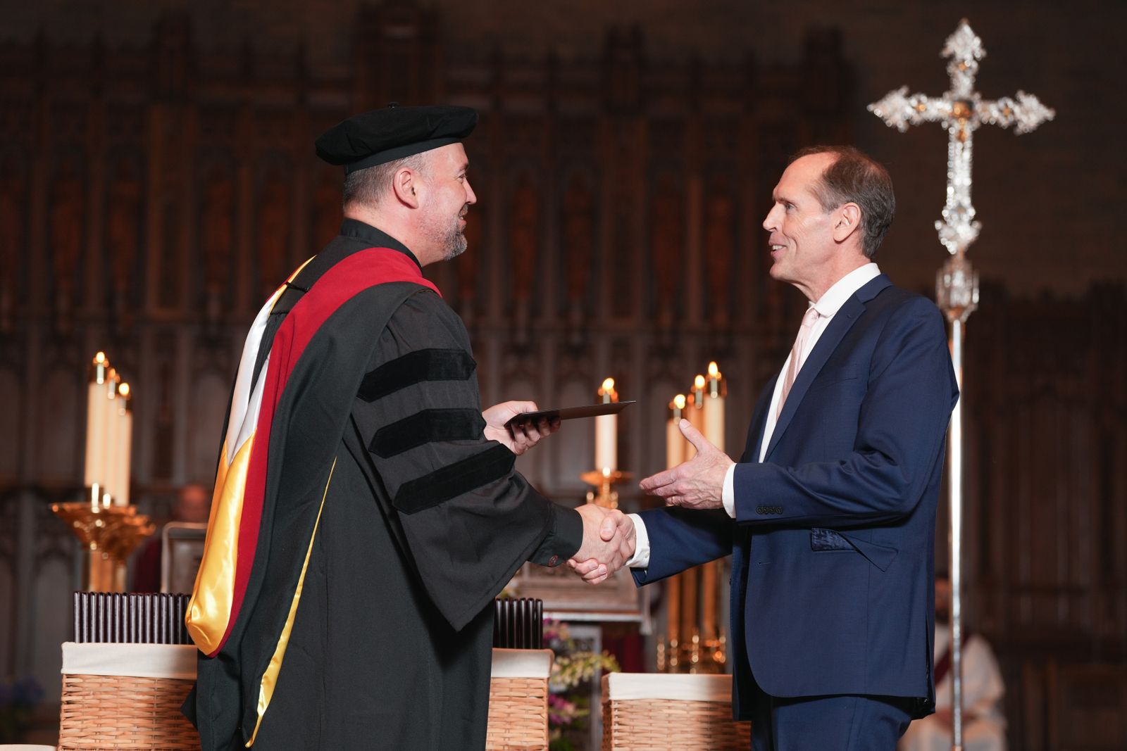 Fr. Stephen Burr, rector of Sacred Heart Major Seminary, hands out diplomas and certificates to this year's 84 graduates.
