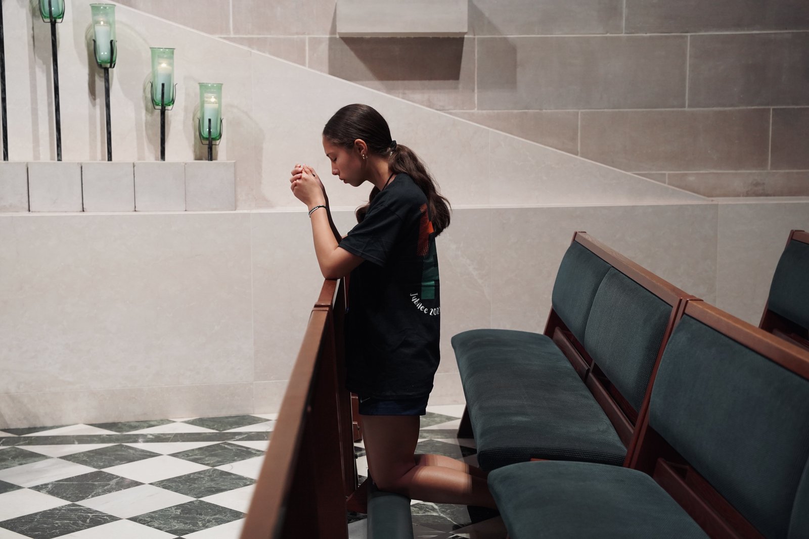 A young person prays in the side chapel of the Cathedral of the Most Blessed Sacrament in Detroit during the Jubilee at Home pilgrimage. The pilgrims visited the cathedral, the Solanus Casey Center in Detroit and St. Colette Parish in Livonia as a part of a spiritual journey in communion with the Jubilee of Young People taking place in Rome at the same time. (Photo by Izzy Cortese | Detroit Catholic)