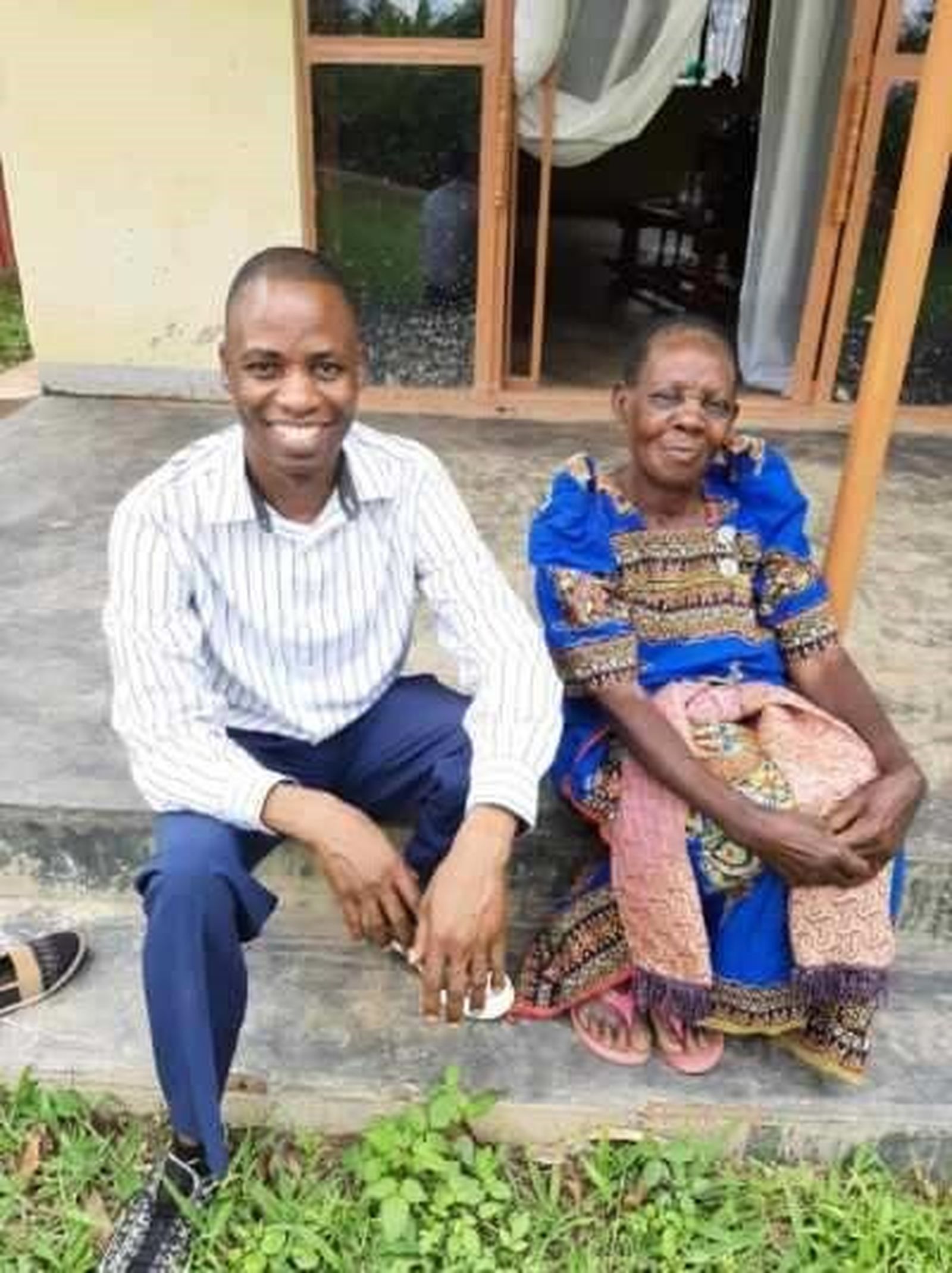 Joseph Kirembwe enjoys a long-awaited visit with his mother, Cotilda Nakamatte, at the family home in Uganda. (Courtesy of Joseph Kirembwe)