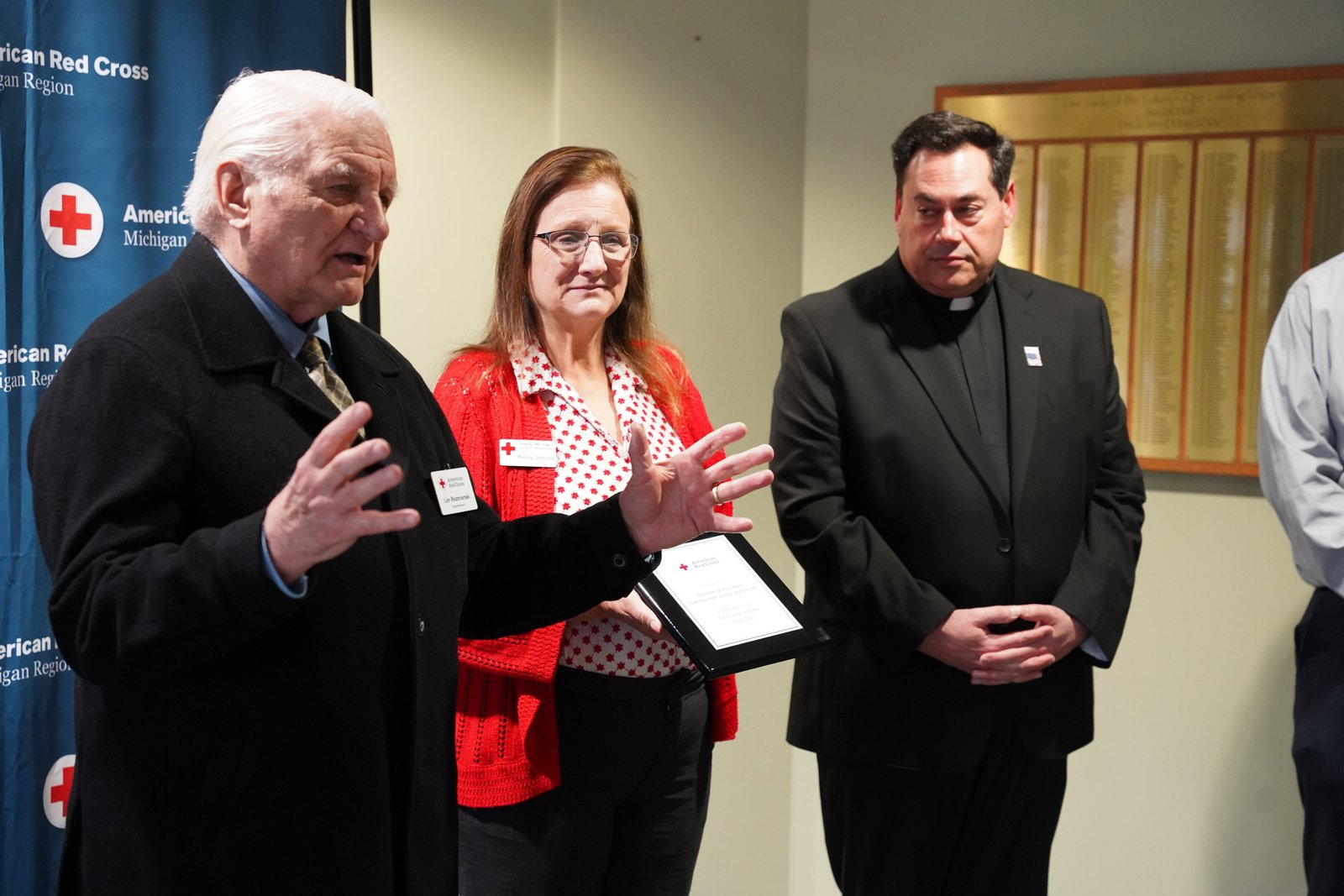 Leonard Rezmierski, a board member of the Southeast Michigan Chapter of the American Red Cross, congratulates the students of Our Lady of Lakes for organizing blood drives that collected 2,635 units of blood since 2020.