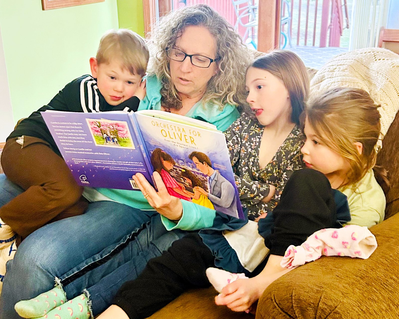 Laura Stewart reads the book to her grandchildren, Oliver's siblings.