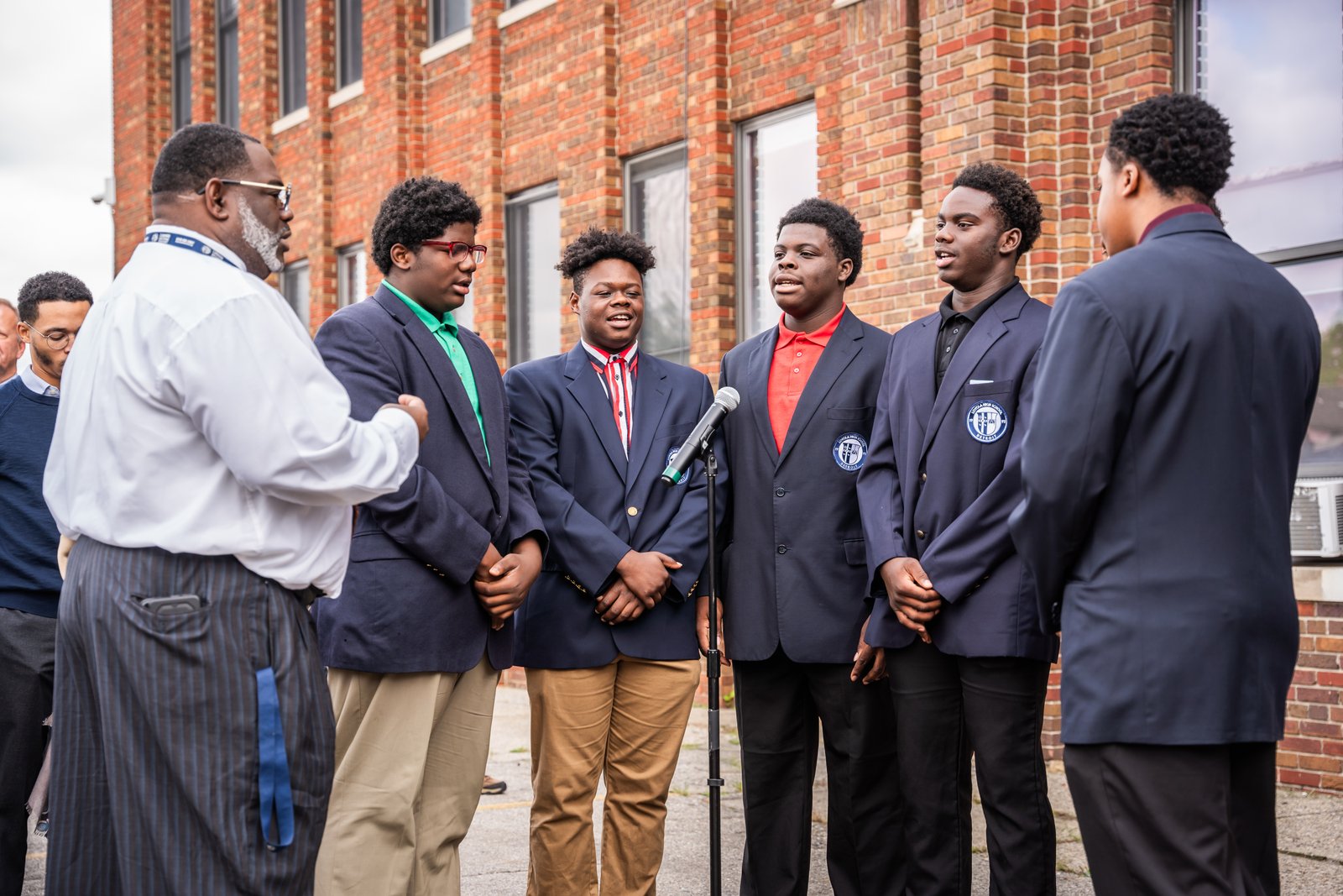 Loyola students sing the school's alma mater before the ceremonial groundbreaking.